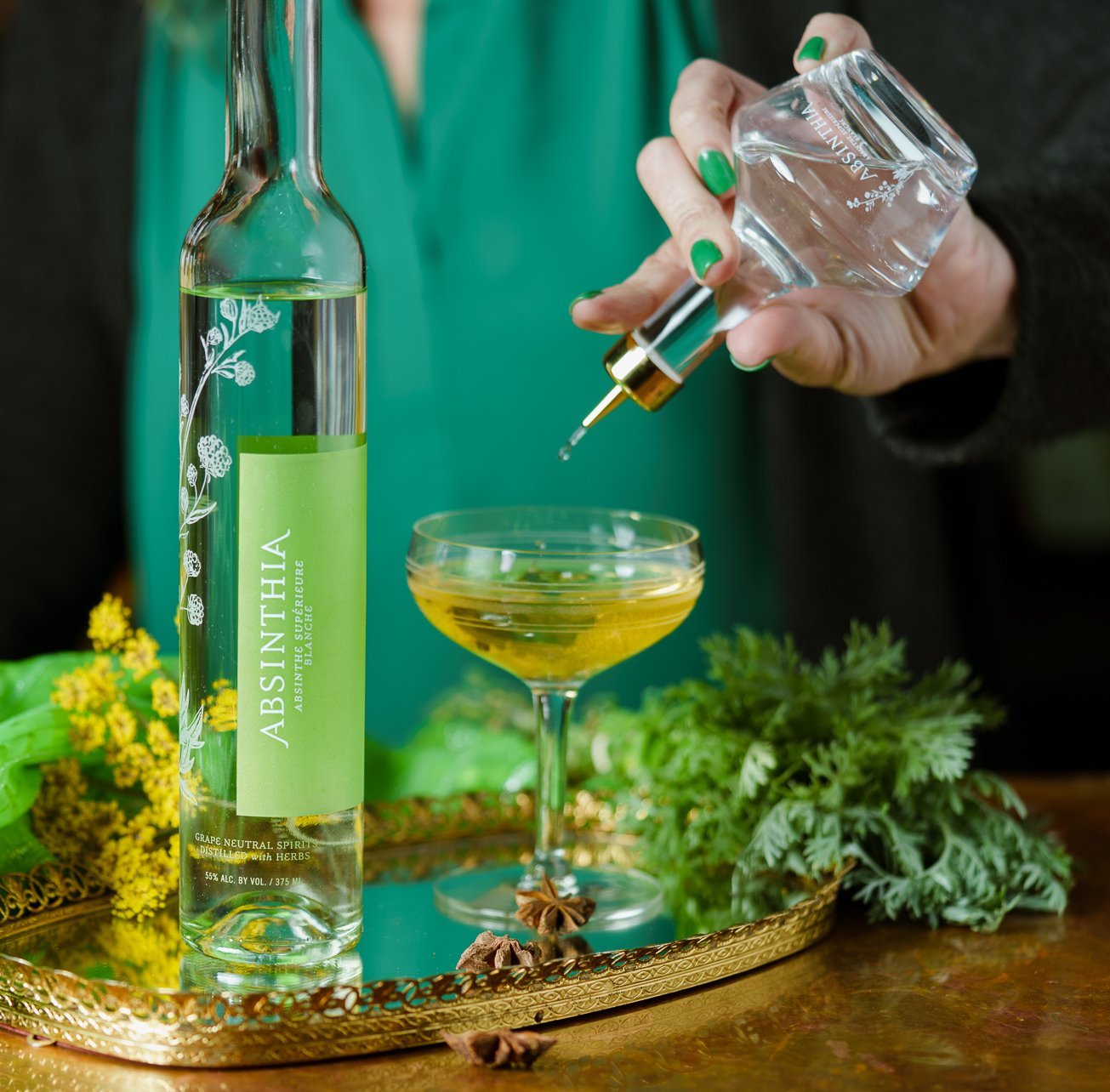 Elegant glass Absinthe Dasher Bottle with gold top, designed for precise pouring.