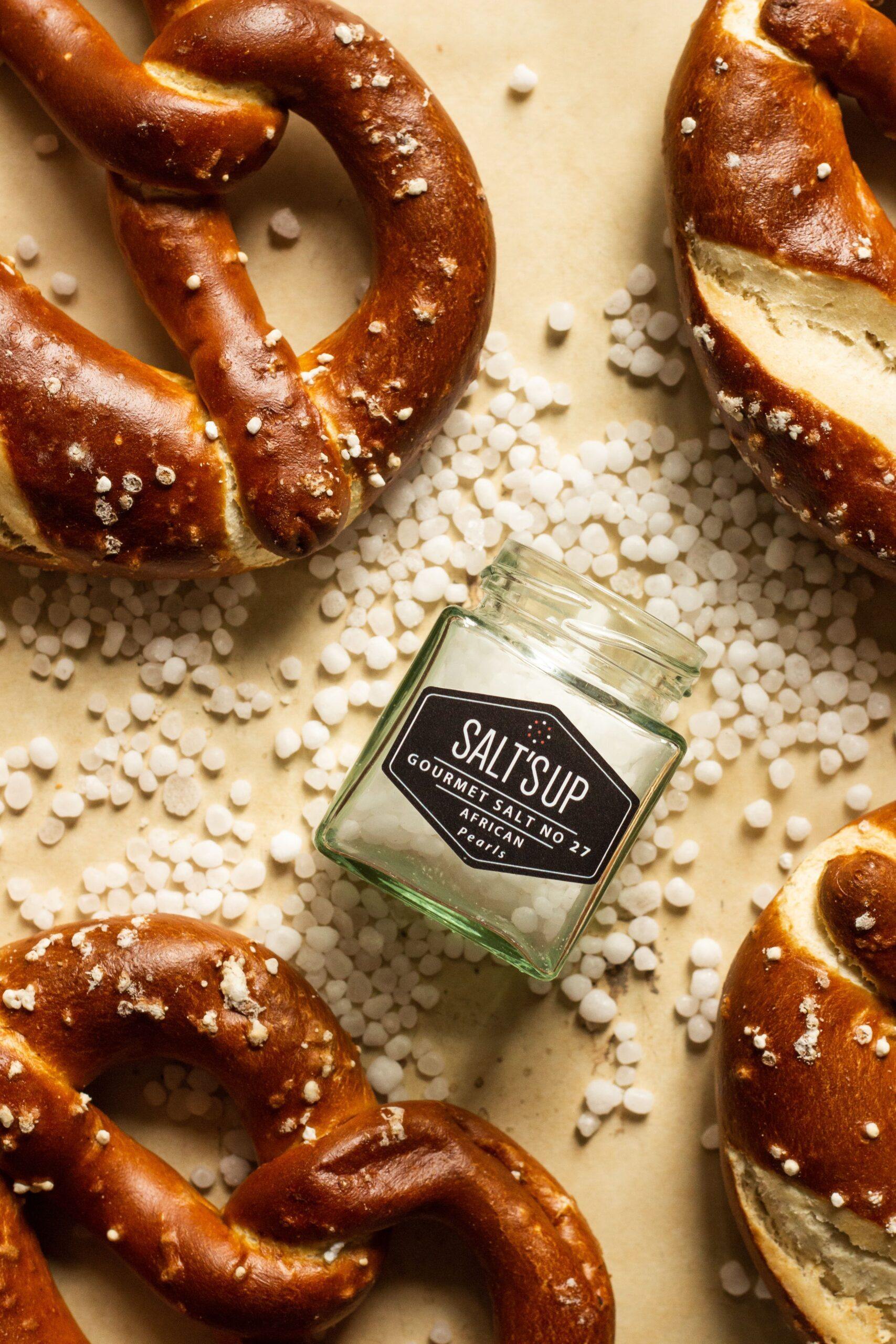 A close-up of AFRICAN SALT pearls in eco-friendly packaging, showcasing their unique texture and mineral-rich composition.