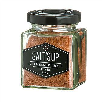 ALAEA fine salt in a glass jar, showcasing its reddish hue and natural texture, ideal for seasoning dishes.