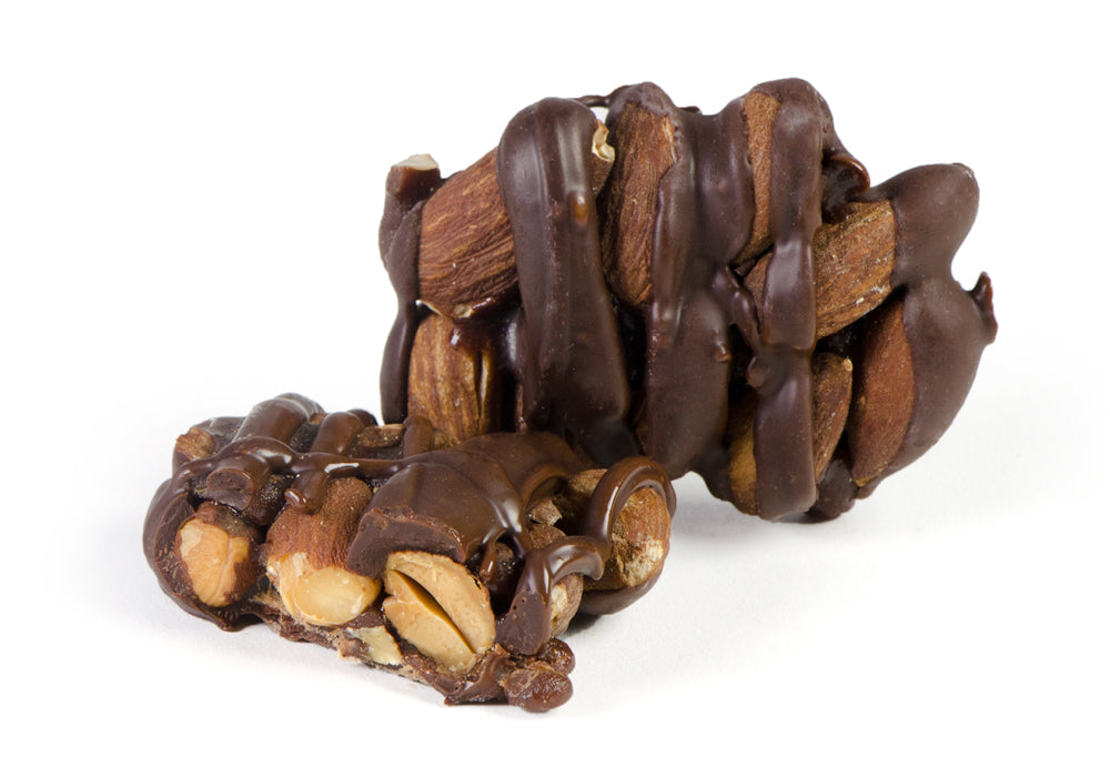 A close-up of Almond Patties, showcasing the rich chocolate coating and crunchy almond filling, beautifully arranged in a 1-pound package.