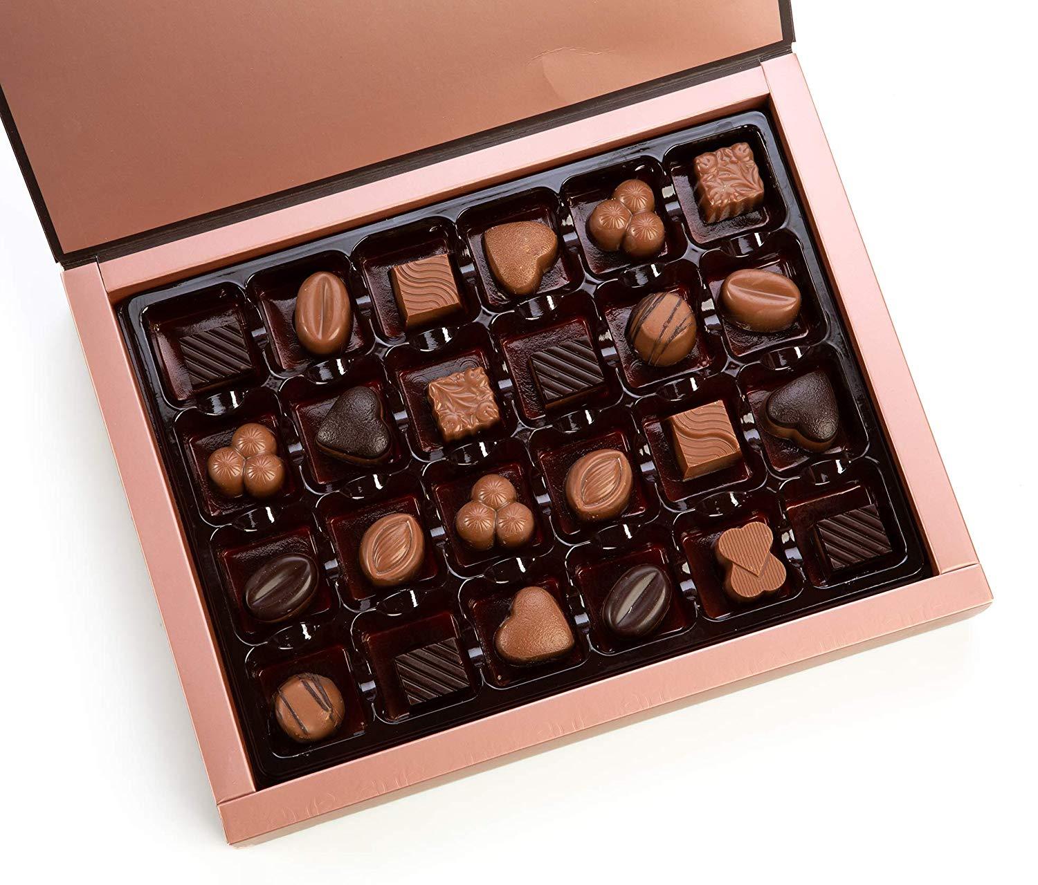 A beautifully arranged box of assorted chocolate truffles featuring various flavors including milk, dark, and white chocolates, elegantly packaged for gifting.