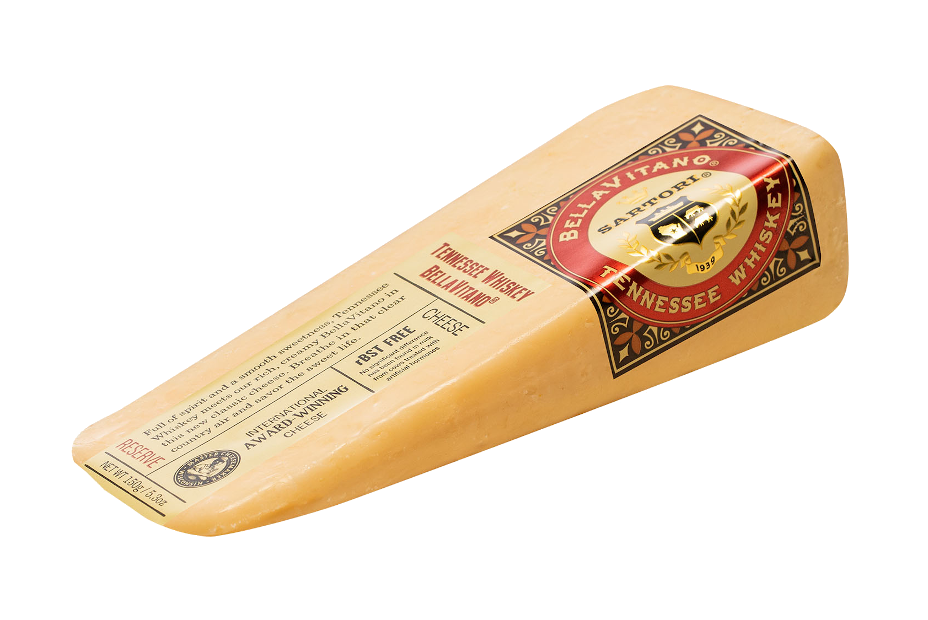 A wedge of BellaVitano Tennessee Whiskey cheese showcasing its creamy texture and rich color, perfect for cheese boards.