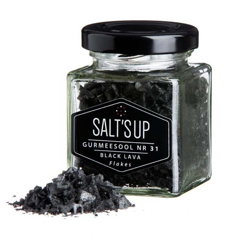 A jar of BLACK LAVA salt flakes showcasing its dramatic black color and flaky texture, ideal for gourmet cooking.