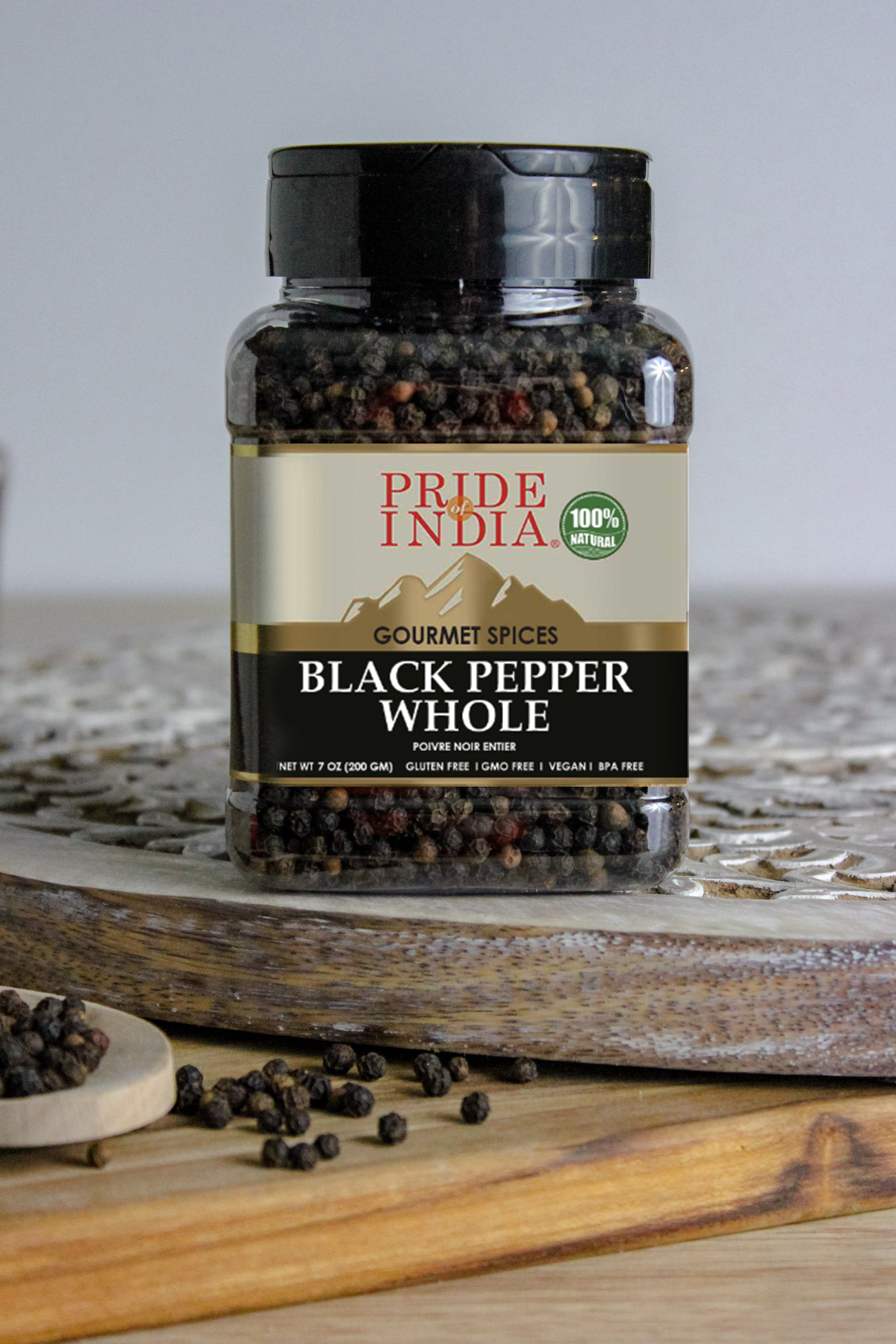 A jar of Black Peppercorn Whole - 8 oz, showcasing whole black peppercorns with a rustic background.