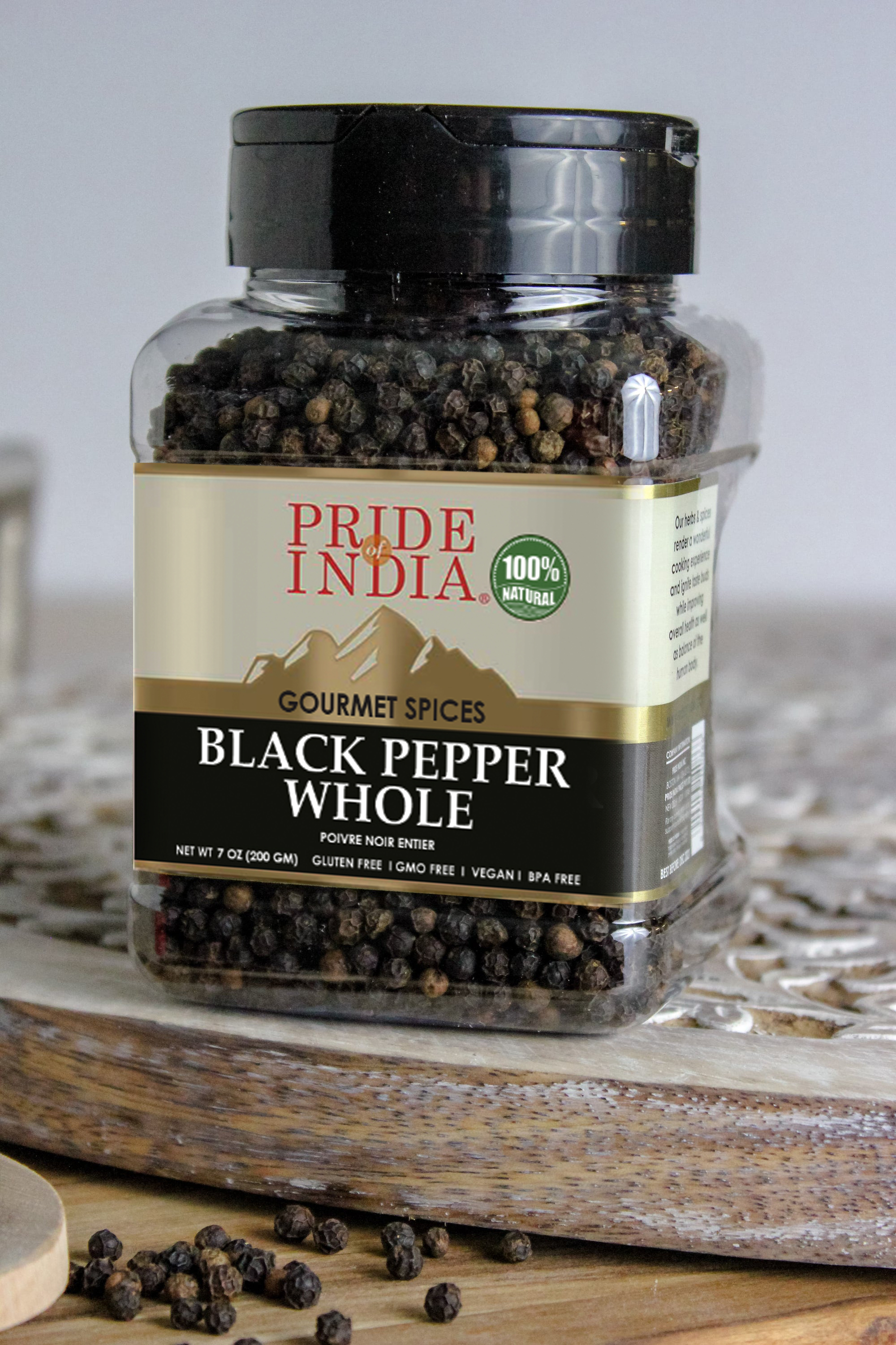 A jar of Black Peppercorn Whole - 8 oz, showcasing whole black peppercorns with a rustic background.