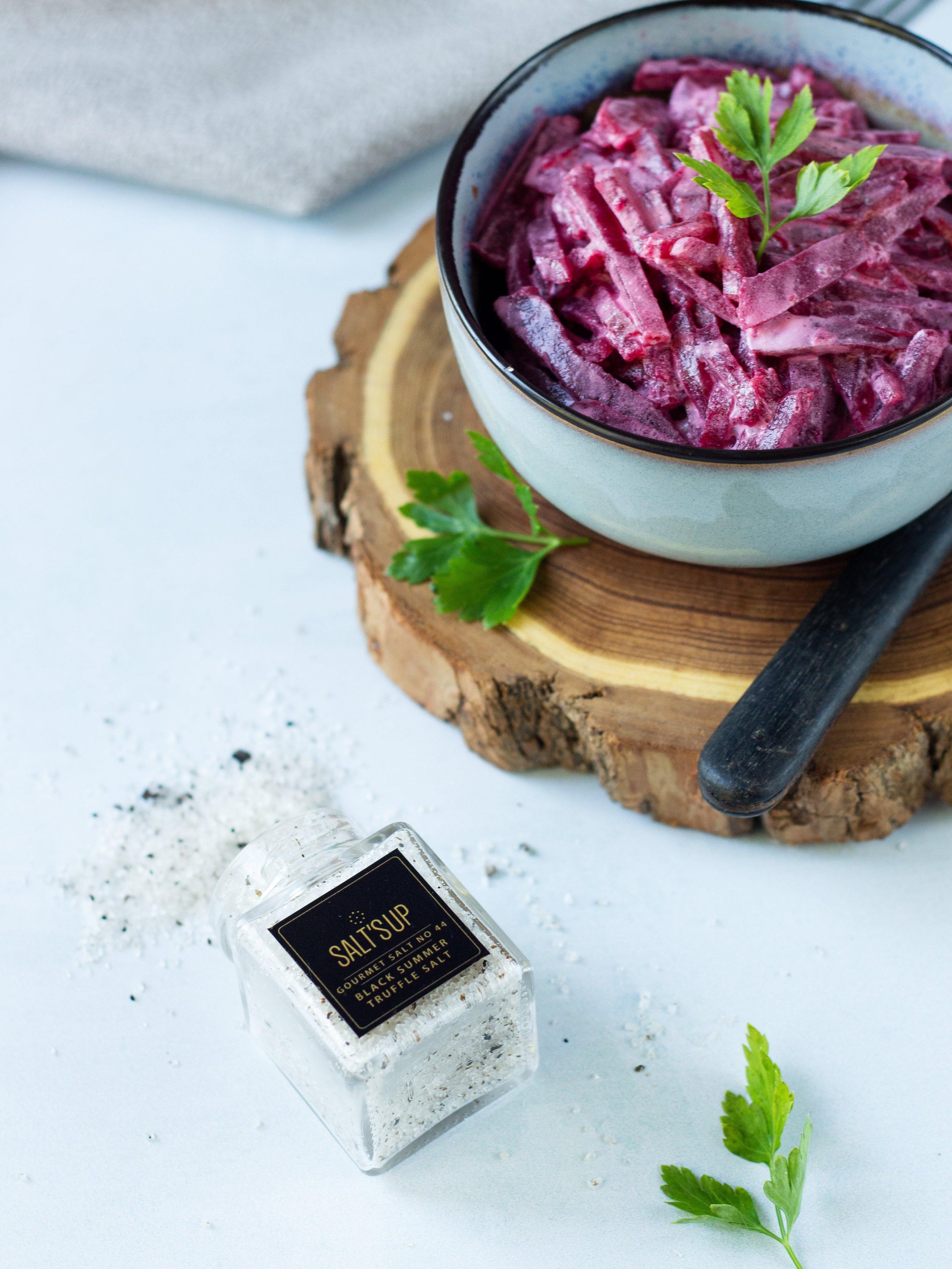 A glass jar of Black Summer Truffle salt showcasing its rich texture and truffle pieces, perfect for gourmet cooking.