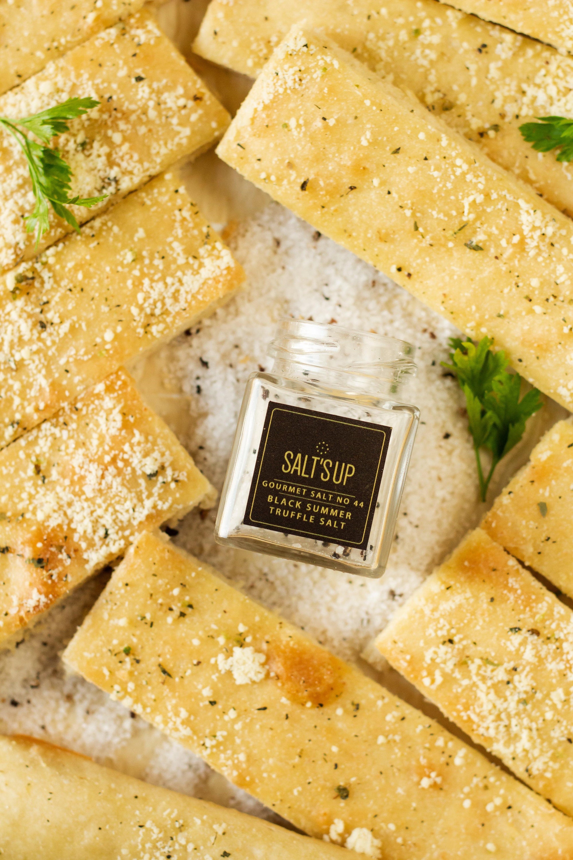 A glass jar of Black Summer Truffle salt showcasing its rich texture and truffle pieces, perfect for gourmet cooking.