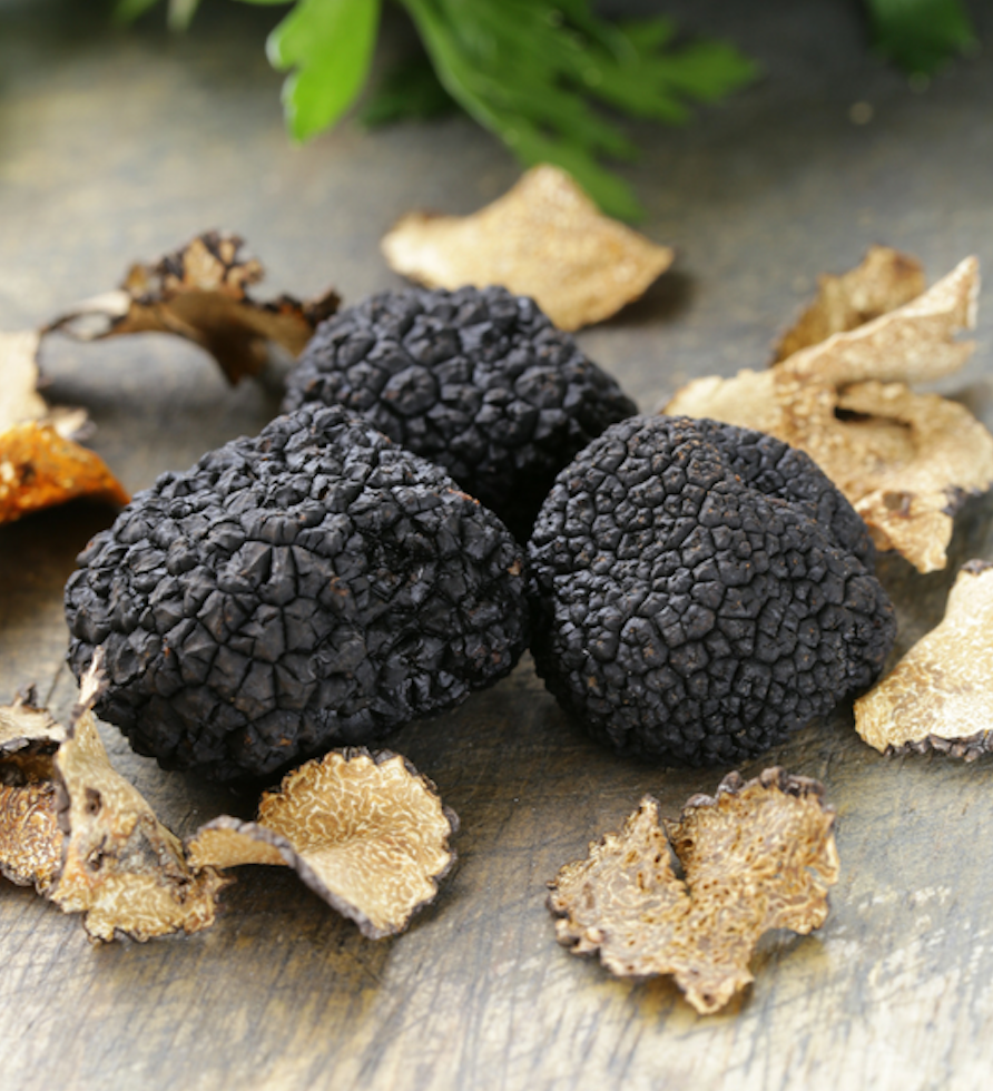 A glass jar of Black Summer Truffle salt showcasing its rich texture and truffle pieces, perfect for gourmet cooking.