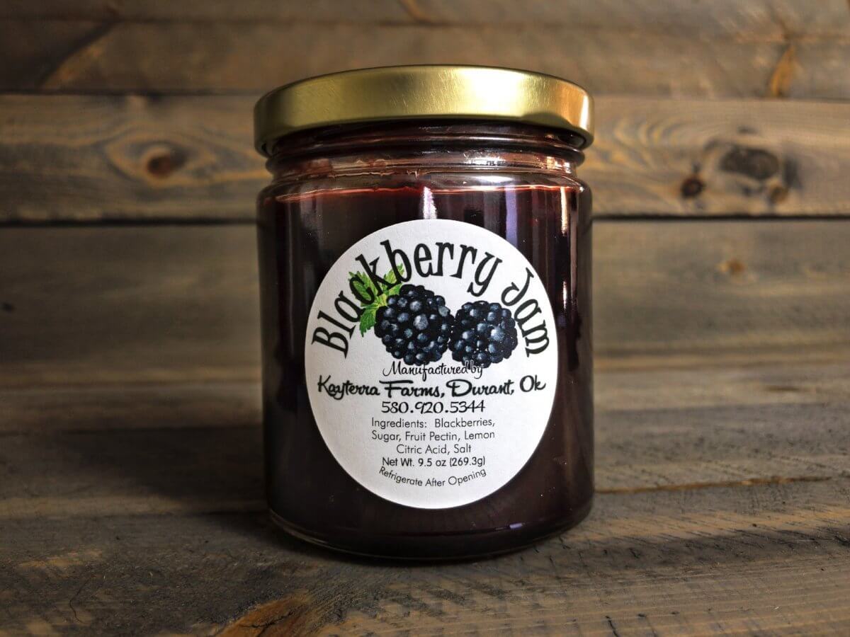 A jar of homemade Blackberry Jam with a rich, dark purple color, showcasing the texture and seeds of the blackberries inside.