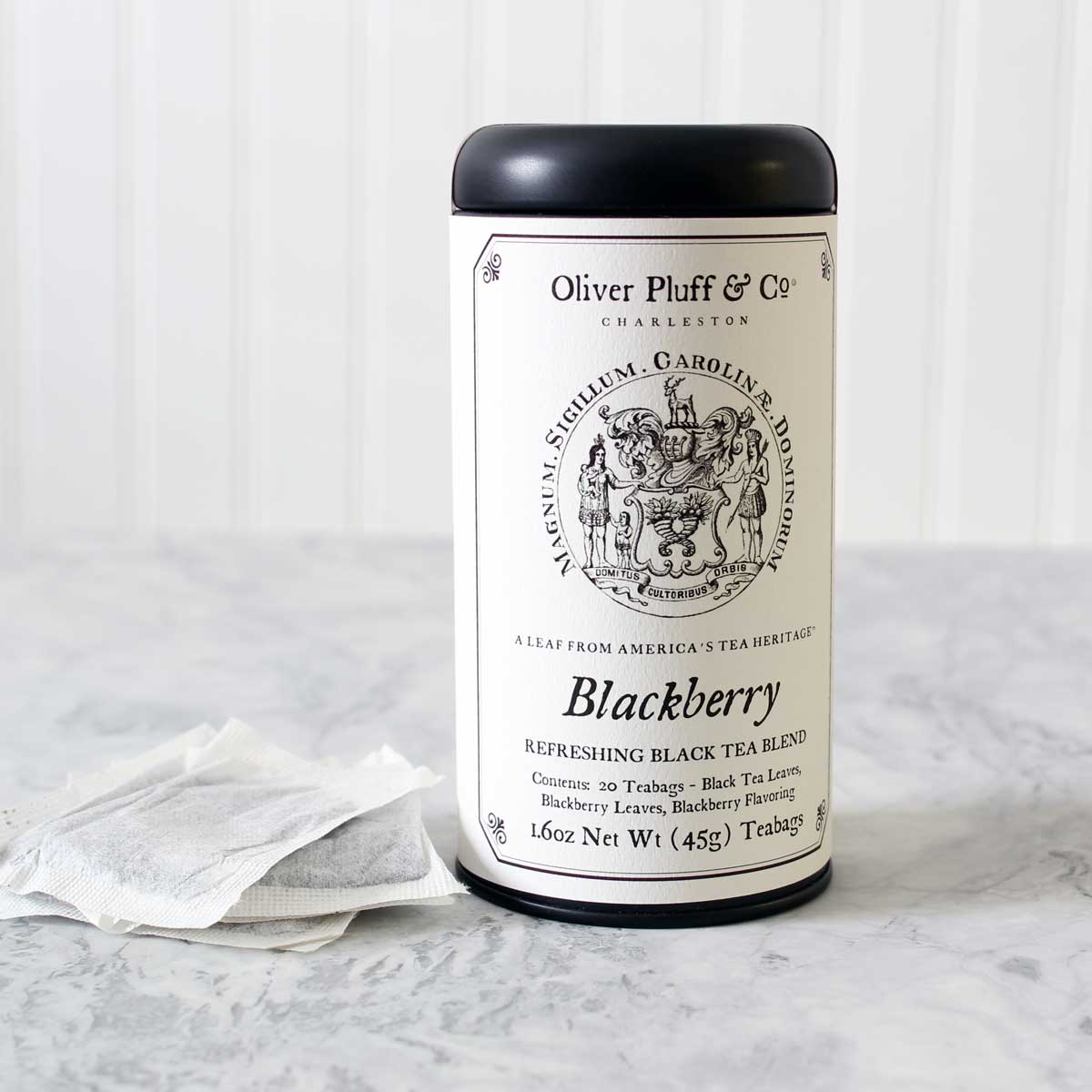 A stylish matte black tea tin filled with Blackberry Teabags, showcasing elegant packaging and a rich tea blend.