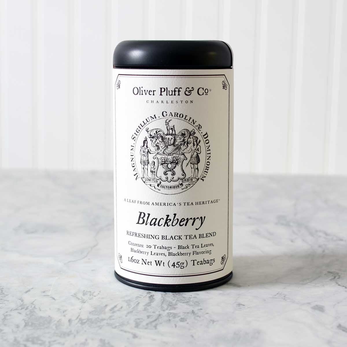 A stylish matte black tea tin filled with Blackberry Teabags, showcasing elegant packaging and a rich tea blend.