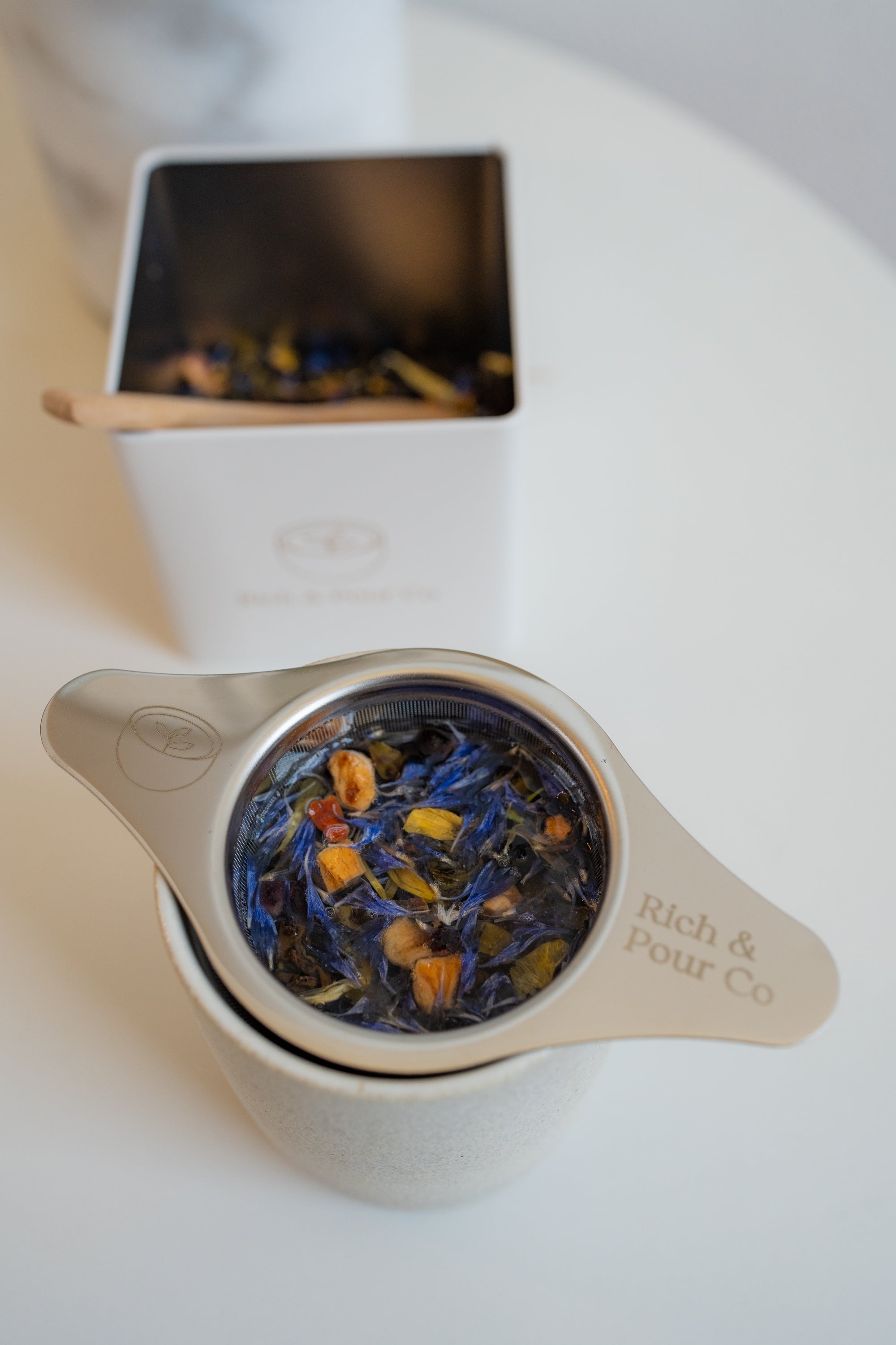 A vibrant package of Blueberry Pie Green Tea Blend featuring blueberry and apple pieces, showcasing its rich flavor profile.