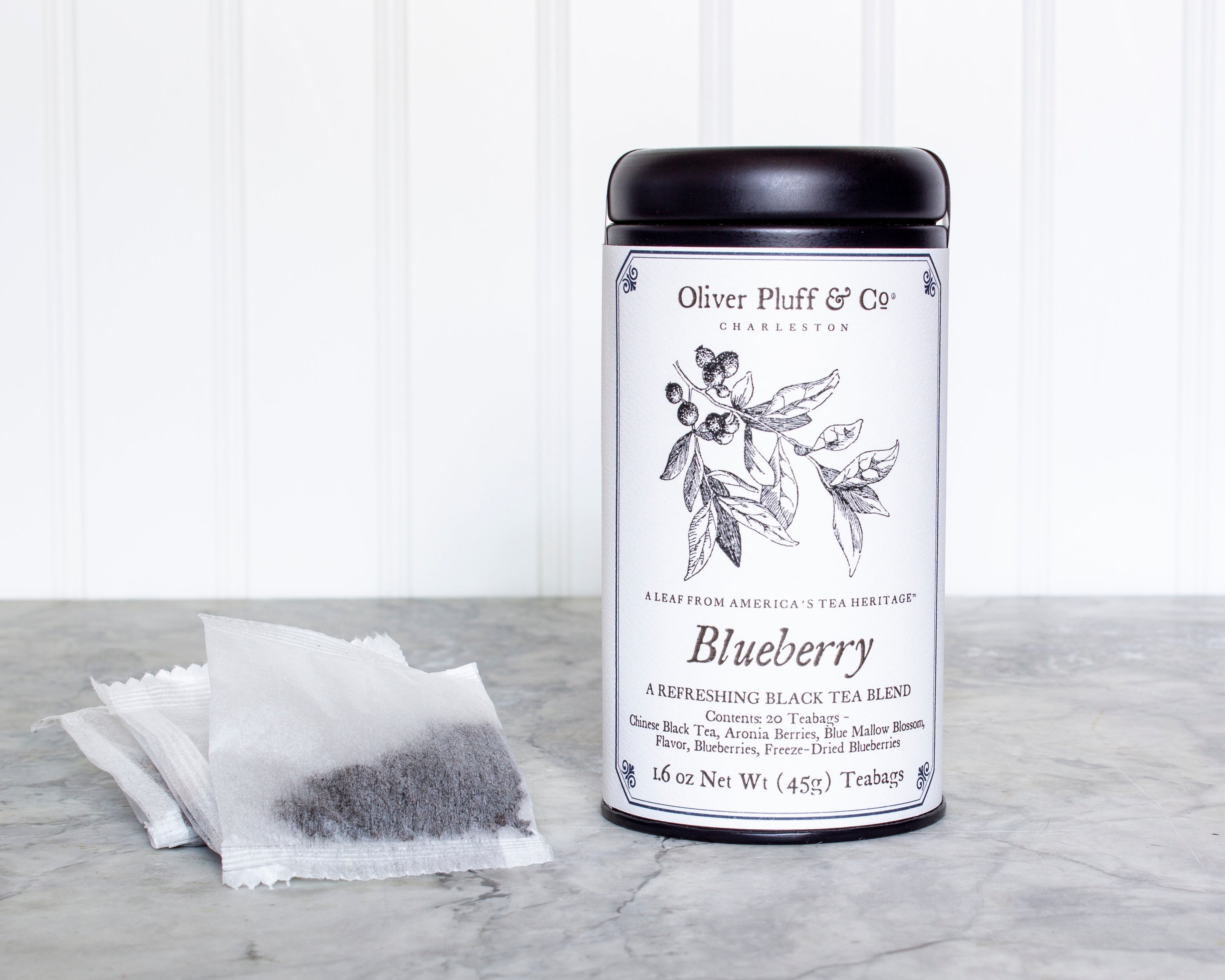 A stylish matte black tea tin containing 20 Blueberry Teabags, featuring a refreshing blend of black tea and blueberries.