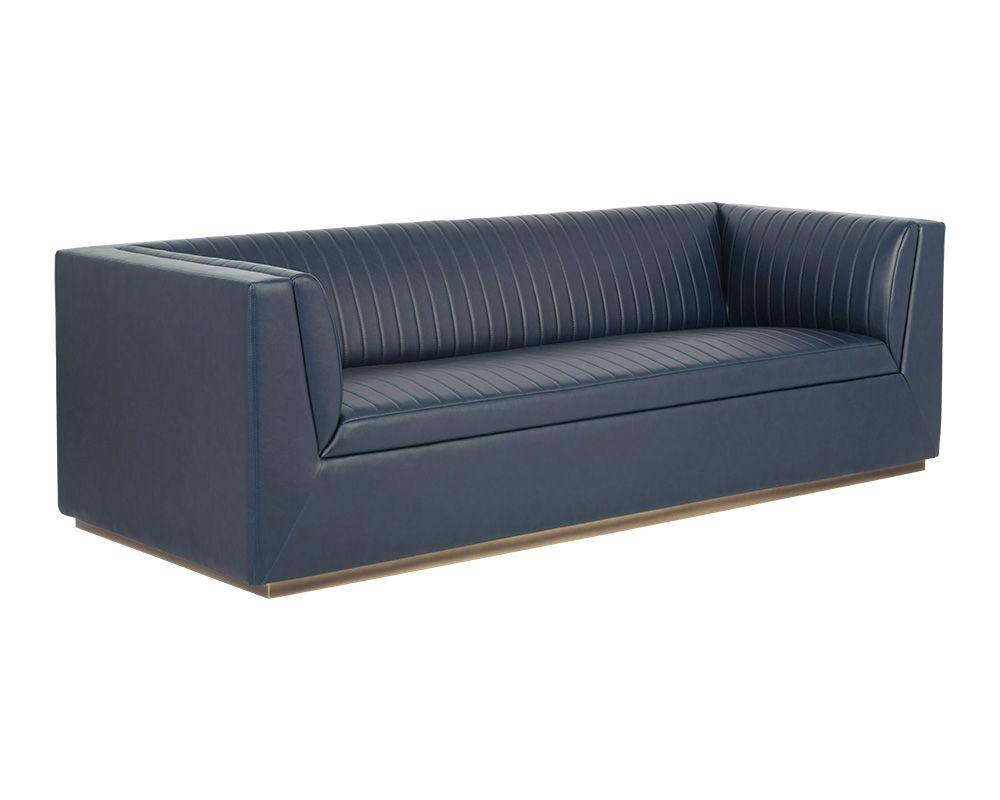 The Bradley Sofa featuring channel tufting in vintage blue faux leather with rustic bronze steel legs.