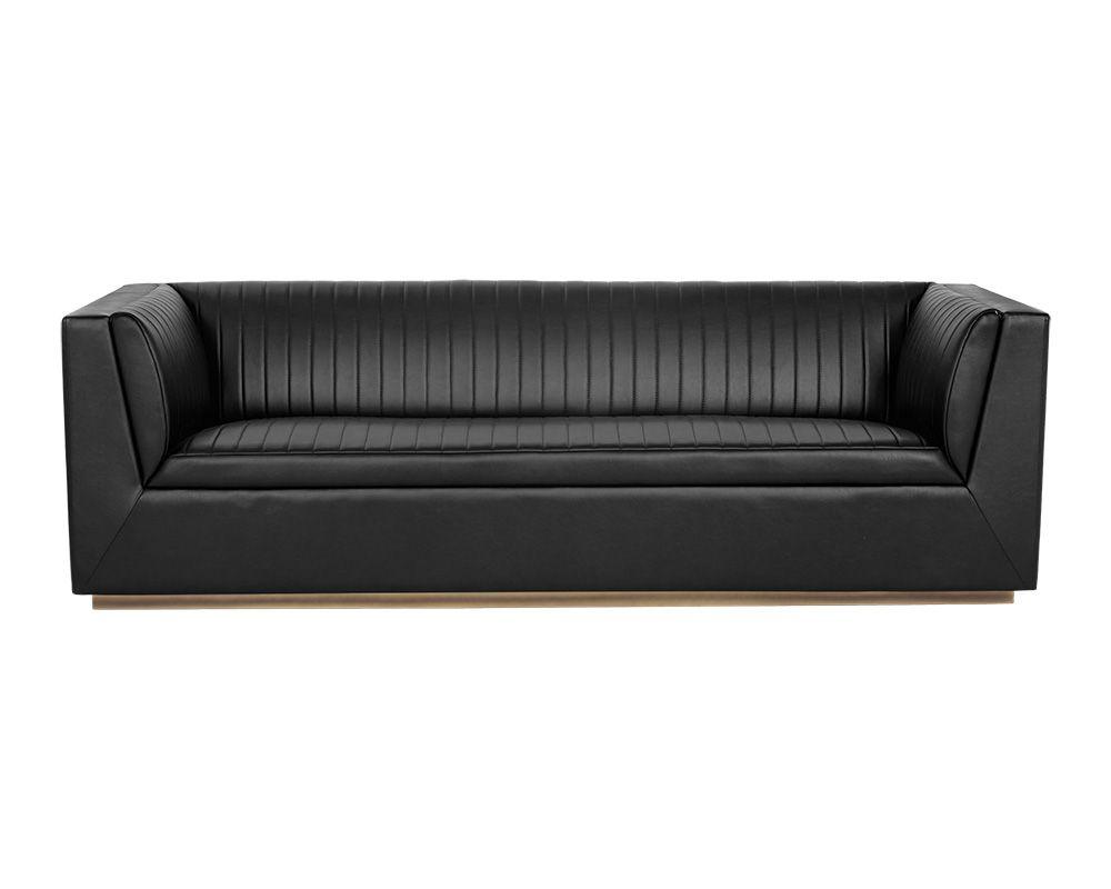 The Bradley Sofa featuring channel tufting in vintage blue faux leather with rustic bronze steel legs.