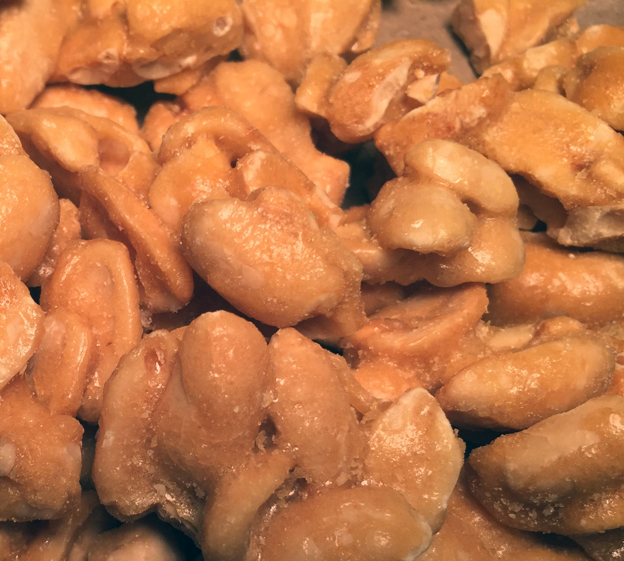 A 5 oz. bag of Brittle Brothers Gourmet Peanut Brittle featuring jumbo Virginia peanuts coated in buttery brittle.