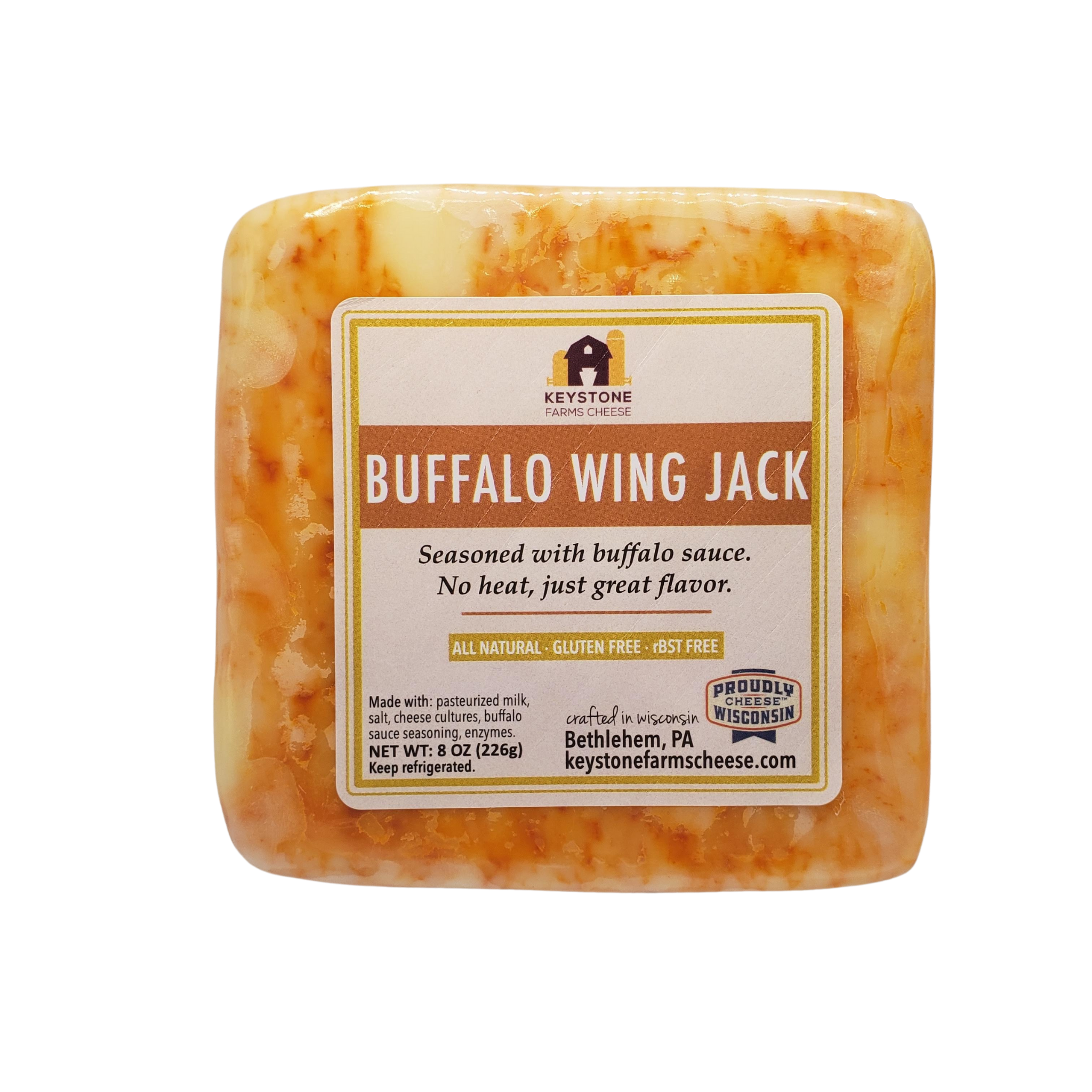 Buffalo Cheddar cheese block infused with buffalo wing sauce, showcasing its creamy texture and vibrant color.