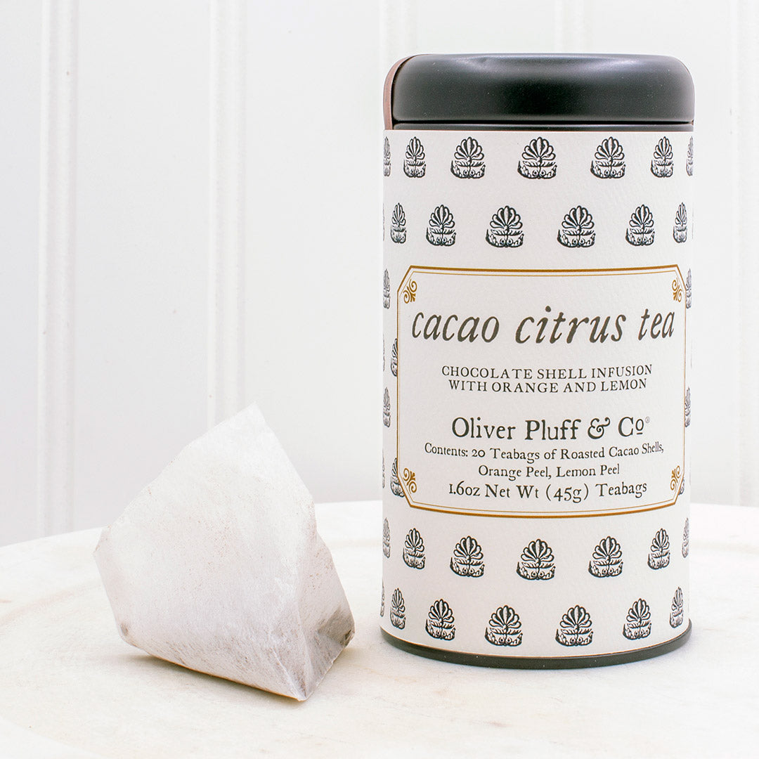 A tin of Cacao Citrus Teabags featuring roasted cacao shells and dried citrus peels, elegantly packaged.