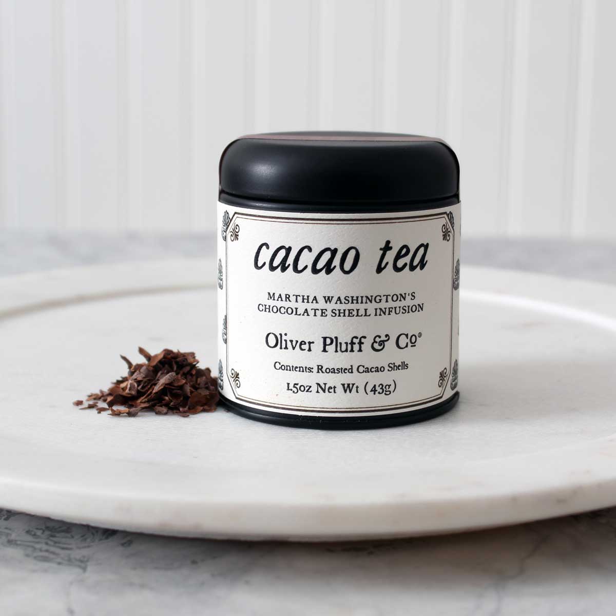 A tin of Martha Washington's Cacao Shell Tea containing loose roasted cacao shells, showcasing its rich chocolatey essence.