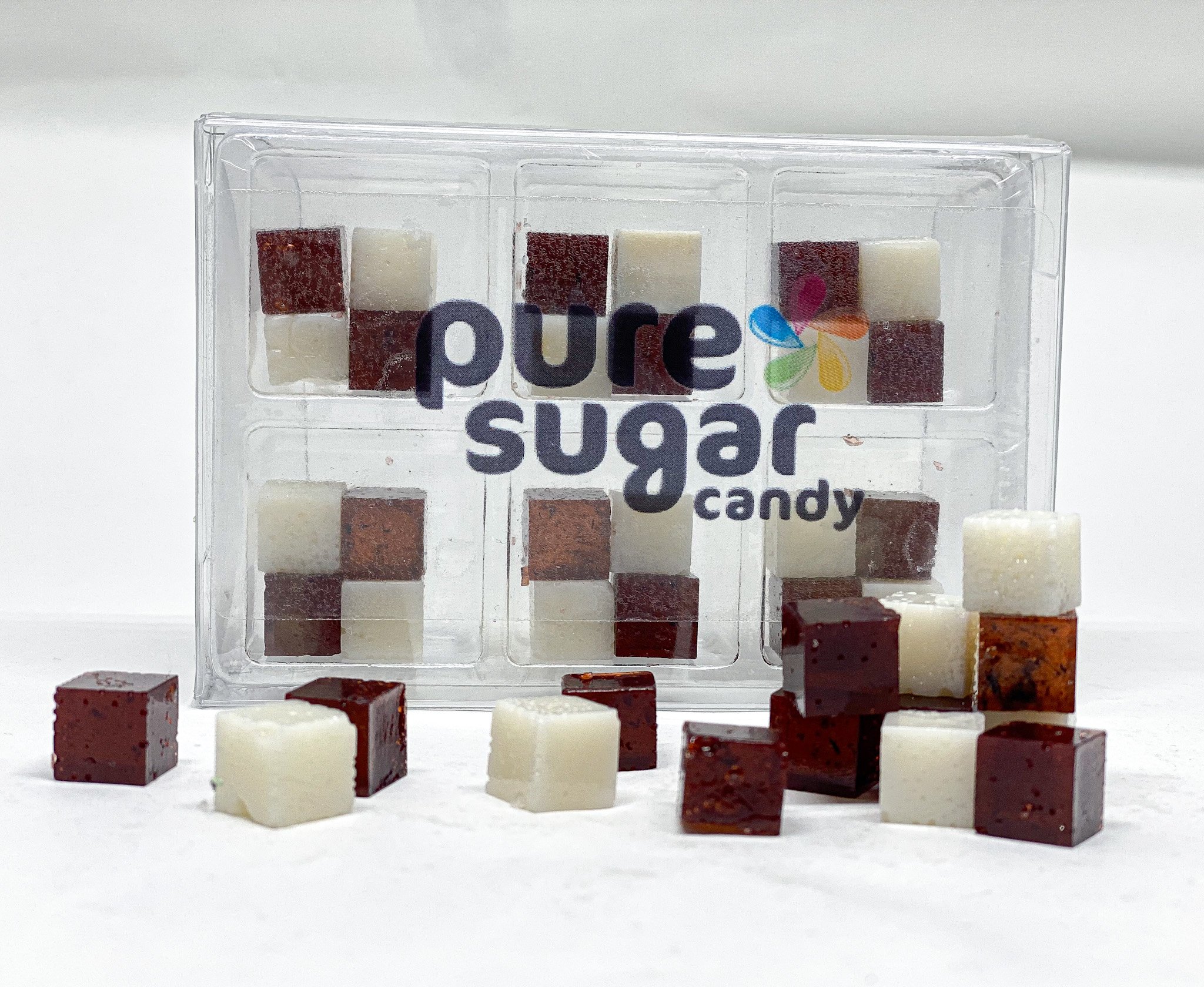 A tray of Cookies and Cream Candy Cubes featuring dark chocolate and vanilla cream cubes, arranged neatly for display.