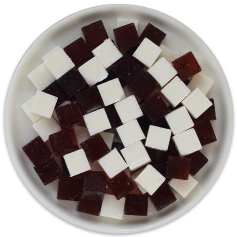 A tray of Cookies and Cream Candy Cubes featuring dark chocolate and vanilla cream cubes, arranged neatly for display.