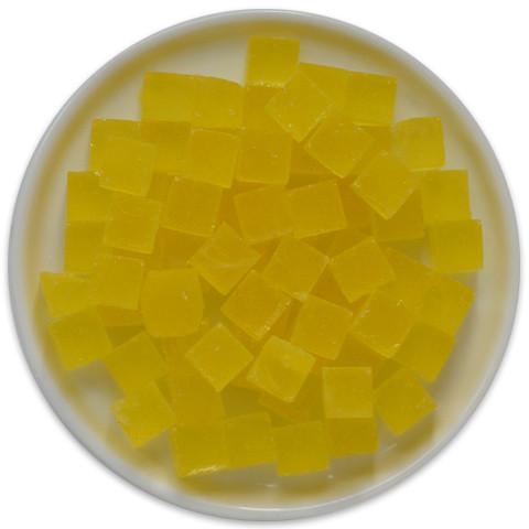 A colorful tray of Candy Cubes - Lemonade, featuring 24 vibrant yellow cubes, each showcasing a refreshing lemonade flavor.