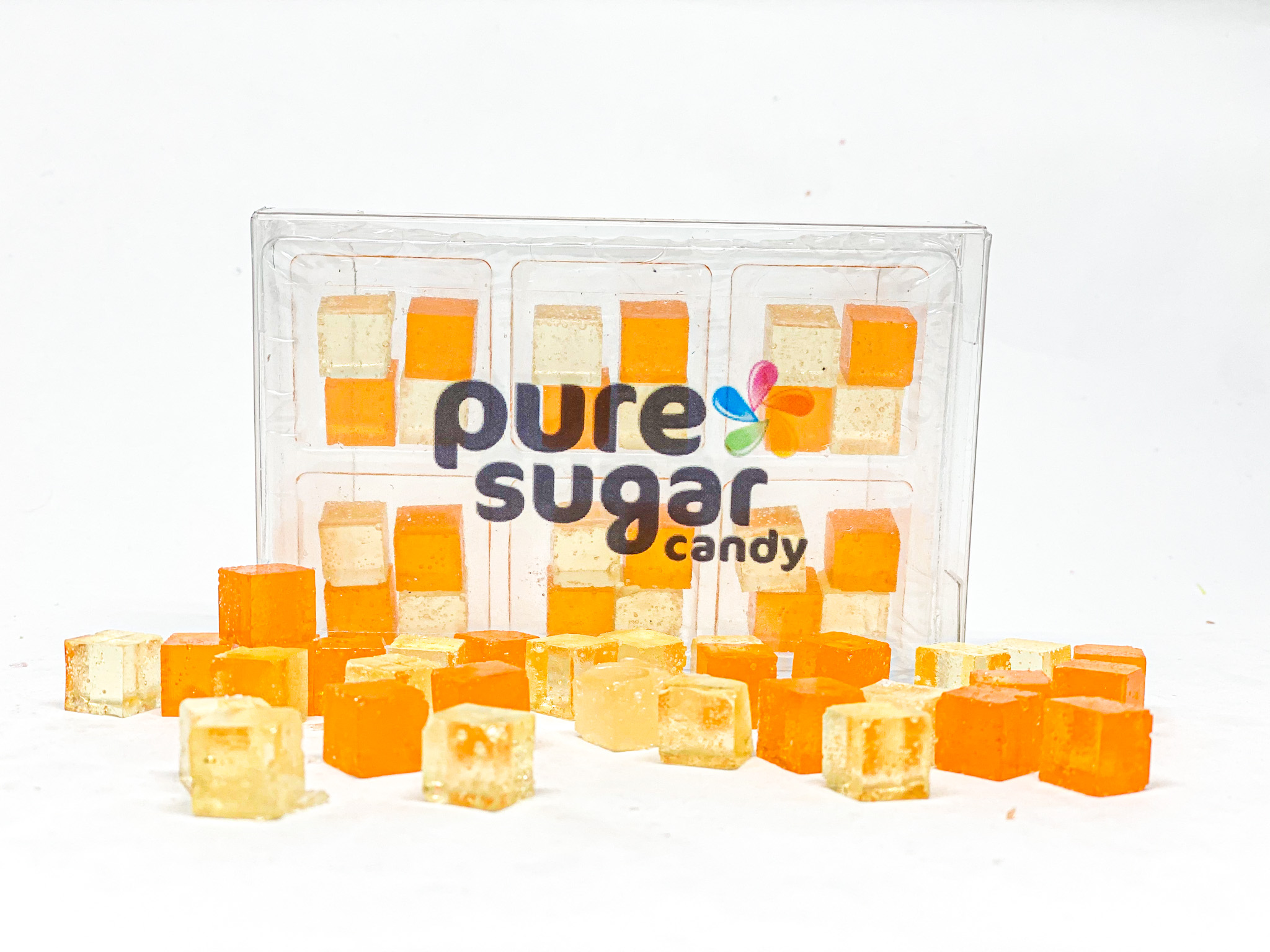 A vibrant tray of Candy Cubes - Mimosa featuring orange and sparkling wine flavors, adorned with edible glitter for a festive look.