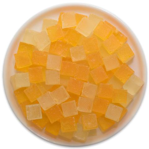 A tray of Candy Cubes in Pumpkin Pie flavor, showcasing vibrant orange and yellow cubes with a festive autumn theme.