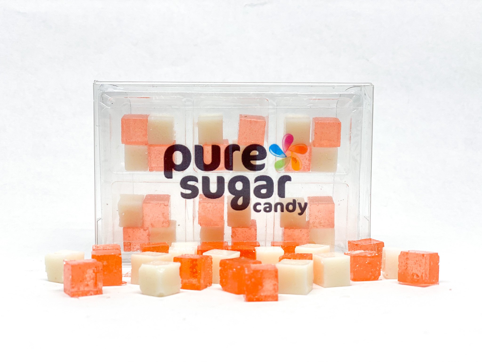 A colorful tray of Strawberry & Cream Candy Cubes, showcasing their vibrant pink and white colors, perfect for snacking.