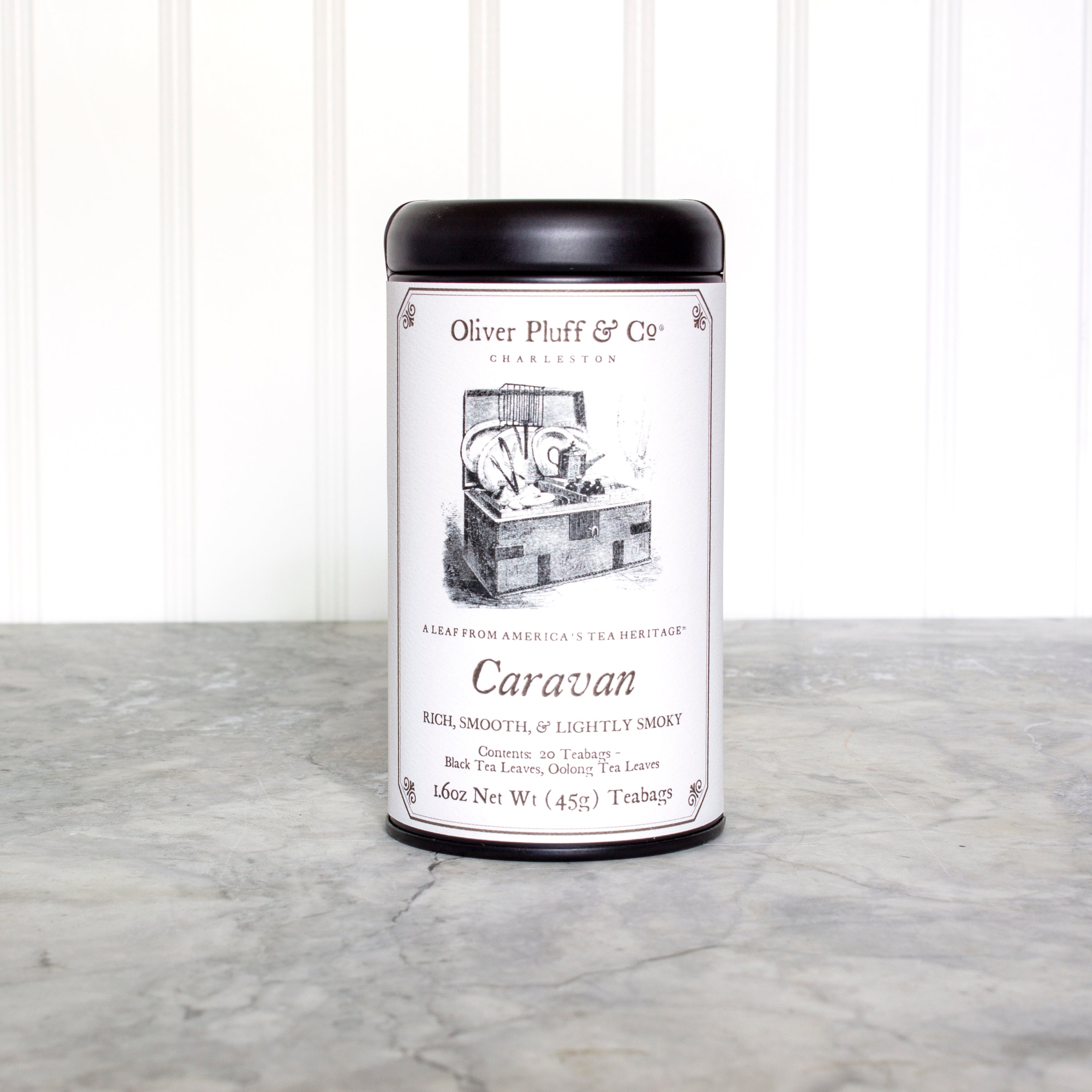 Caravan Teabags in a matte black signature tin, showcasing 20 pyramid-style teabags with a rich, smoky black tea blend.