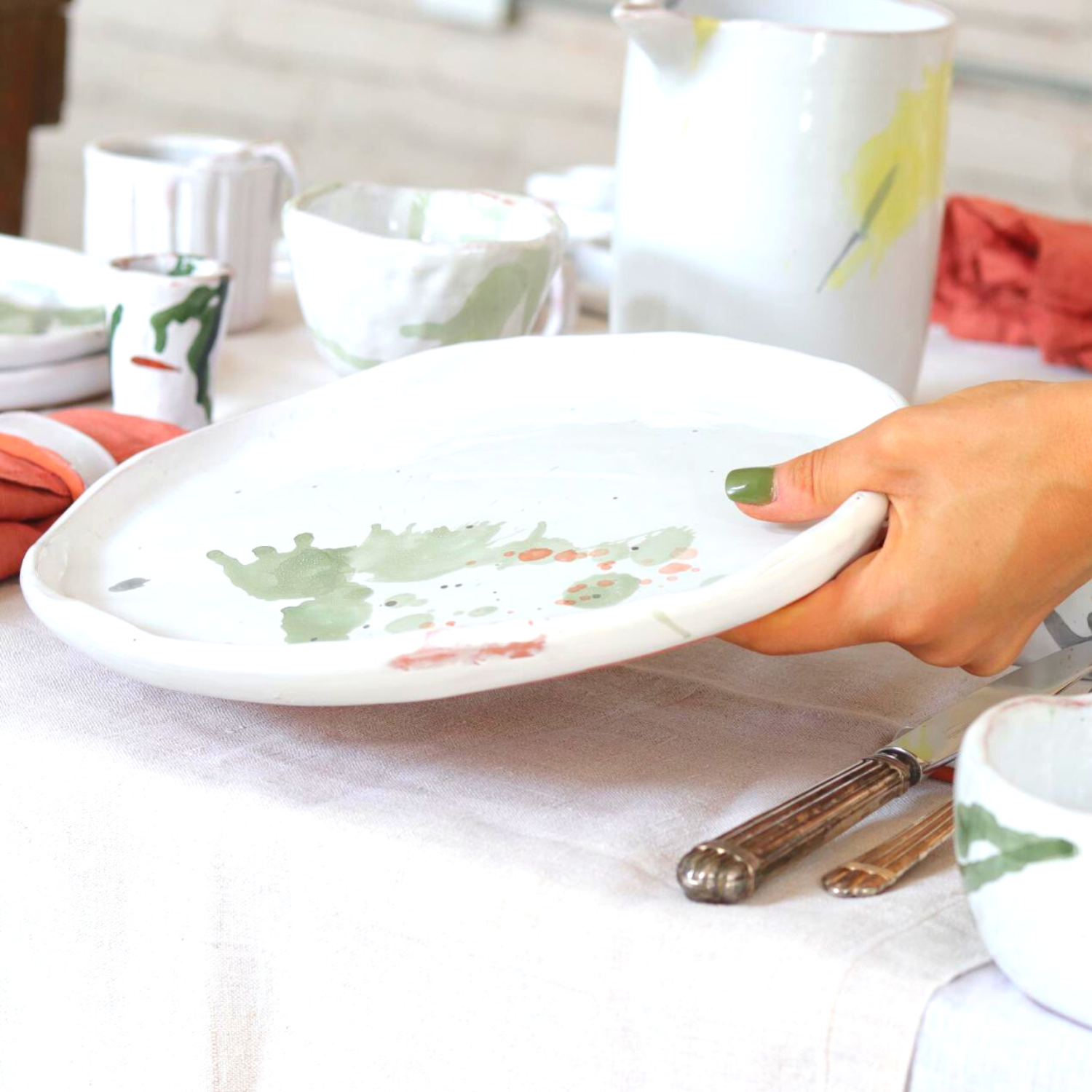 Ceramic Handmade Dinnerplate featuring a unique watercolour design in shades of green, grey, blue, and subtle orange, showcasing artisanal craftsmanship.