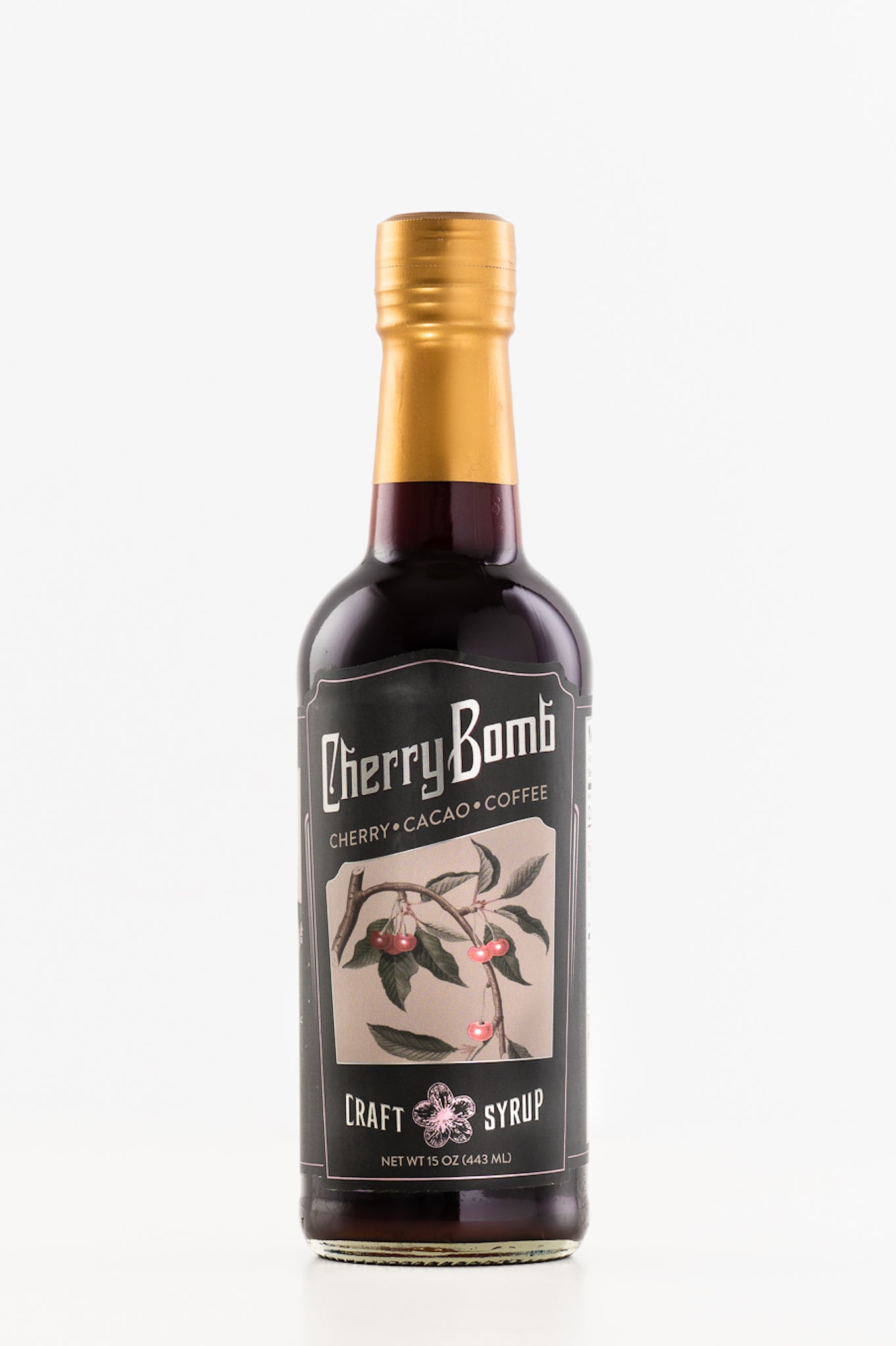 A bottle of Cherry Bomb Syrup featuring a rich blend of cherry, coffee, and cacao, with a vibrant label showcasing its all-natural ingredients.