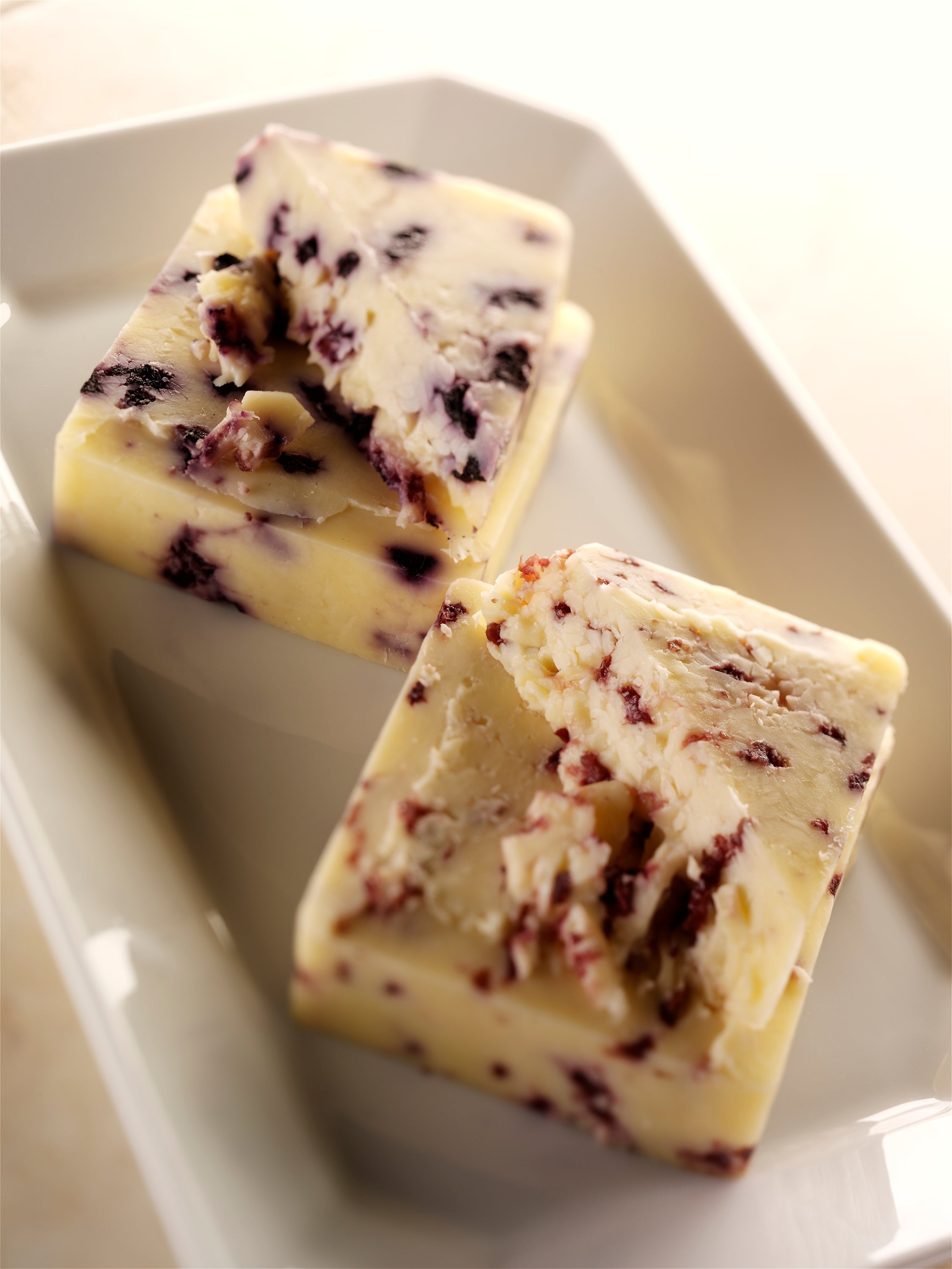 Cherry Infused Cheddar cheese with real cherries, showcasing its creamy texture and vibrant color.