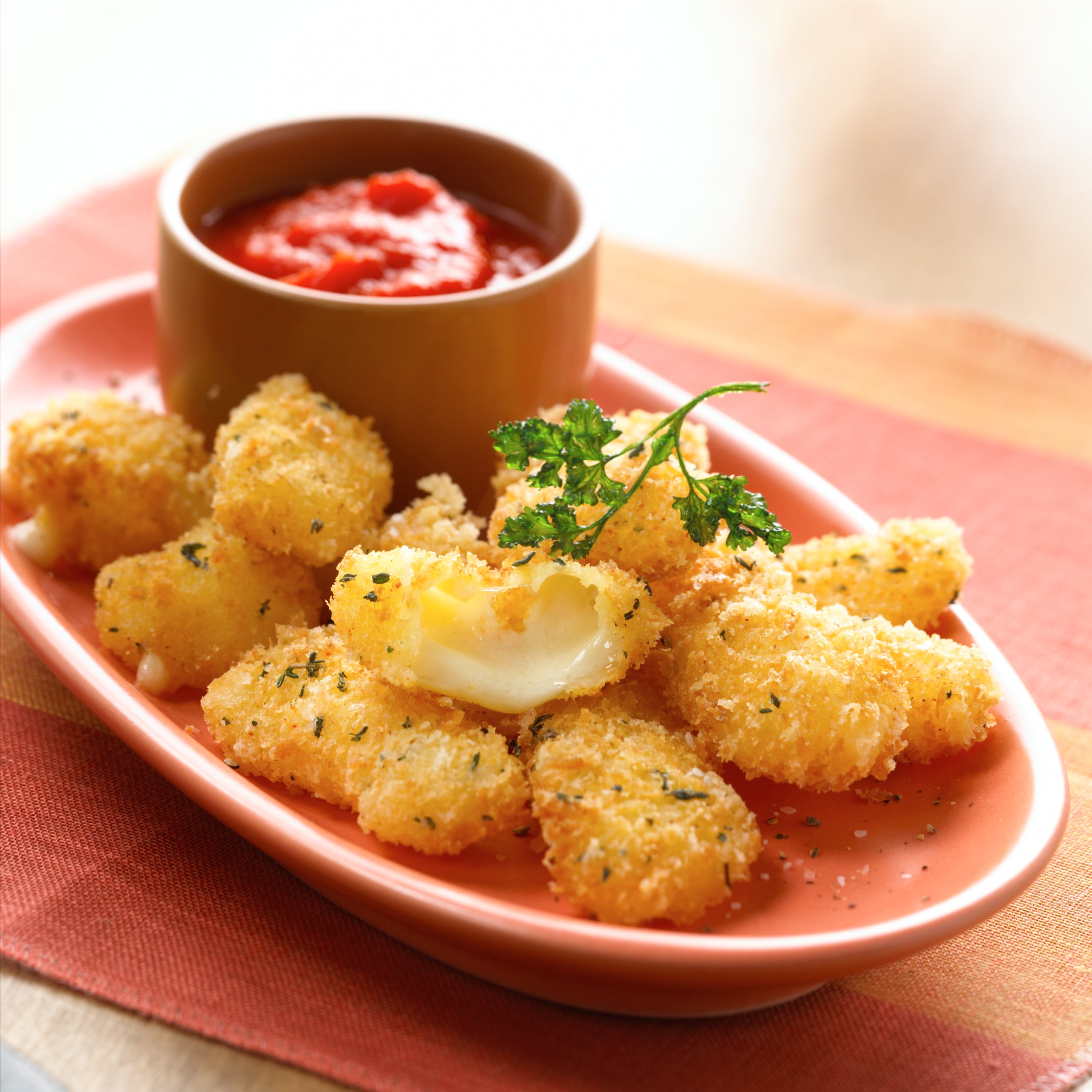 A close-up of fresh white cheese curds, showcasing their irregular shapes and creamy texture, perfect for snacking or cooking.