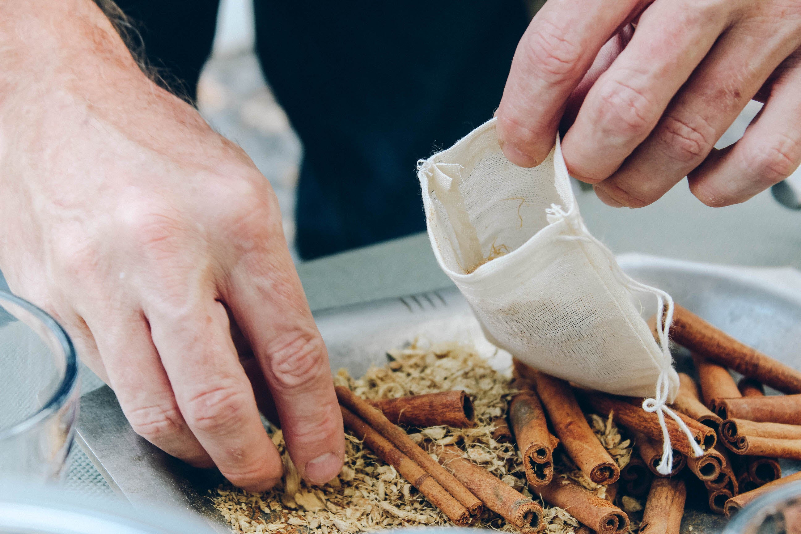 Cider Spices Wassail Kit featuring muslin spice bags, cinnamon sticks, ginger, and nutmeg, beautifully packaged for brewing mulled cider.