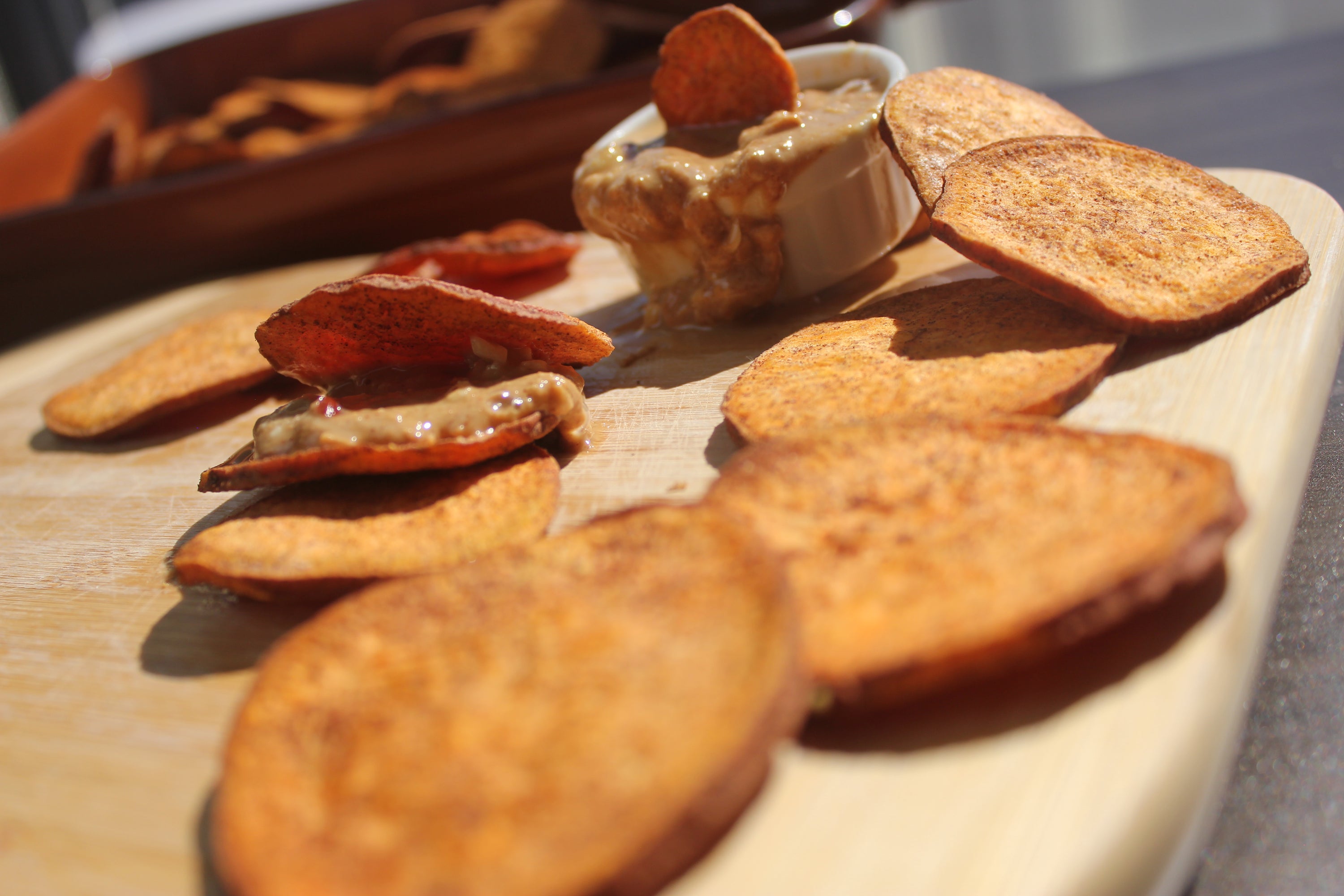 A close-up of organic cinnamon sweetpotato slices, showcasing their golden-brown color and texture, perfect for snacking or dessert toppings.