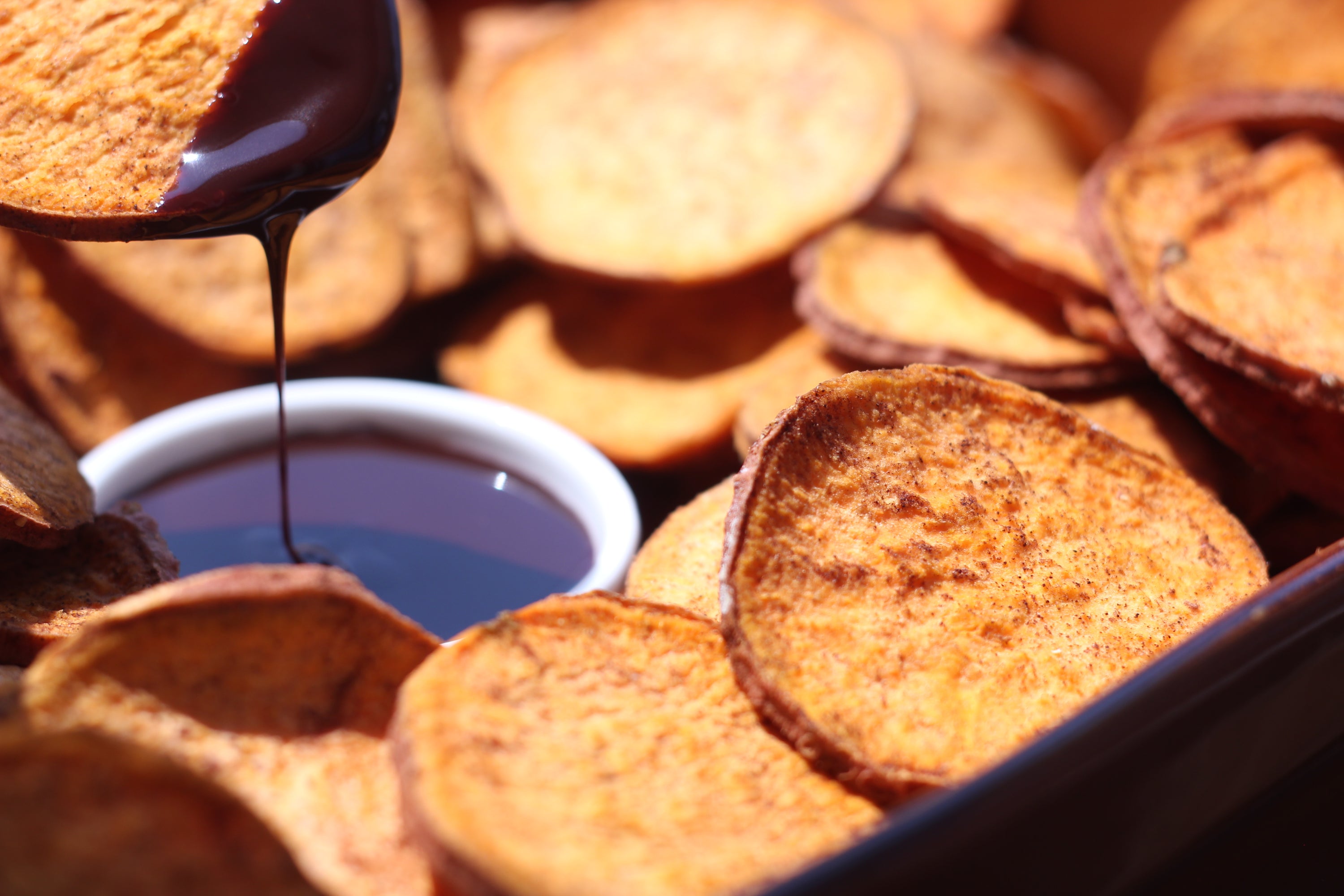 A close-up of organic cinnamon sweetpotato slices, showcasing their golden-brown color and texture, perfect for snacking or dessert toppings.