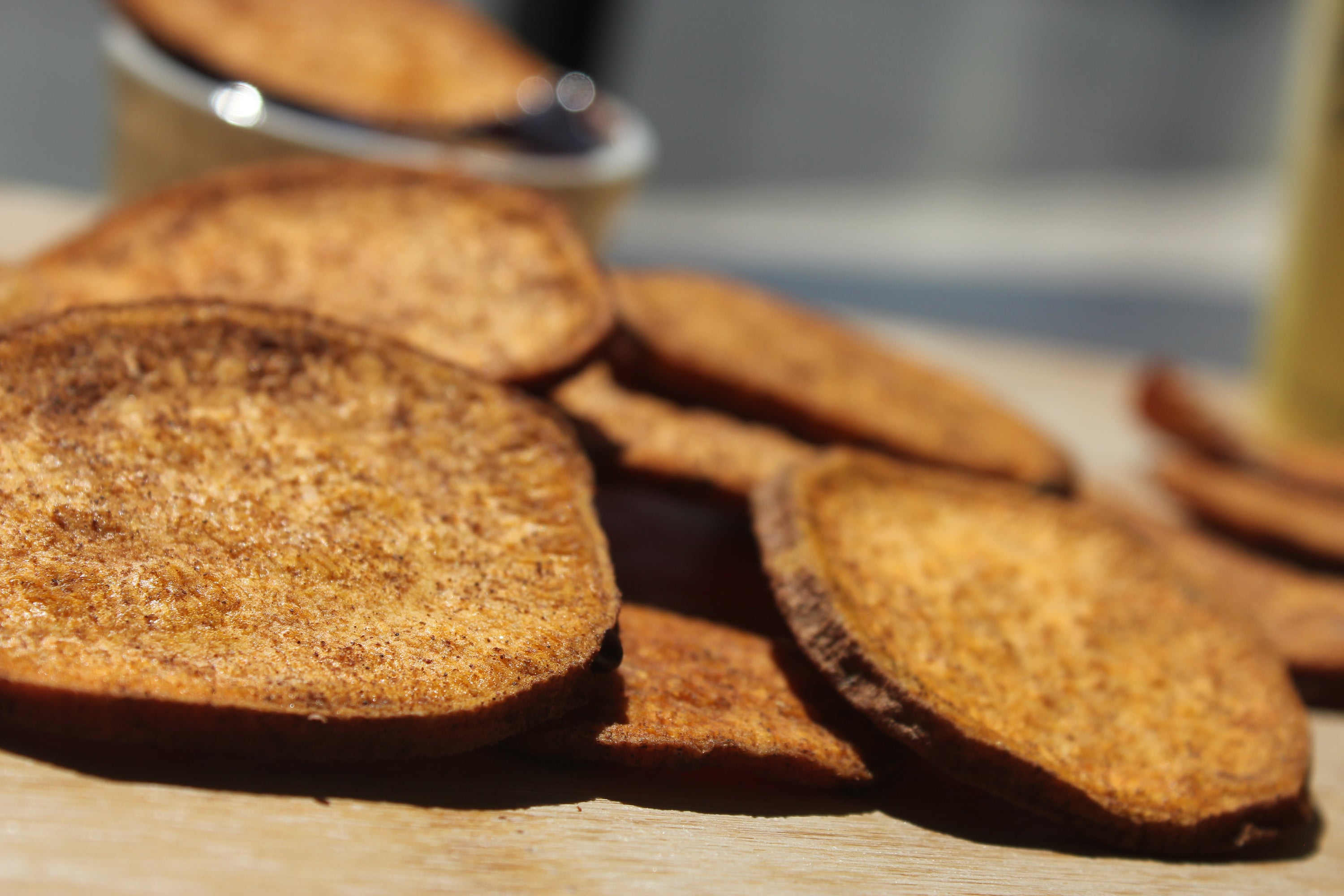 A close-up of organic cinnamon sweetpotato slices, showcasing their golden-brown color and texture, perfect for snacking or dessert toppings.