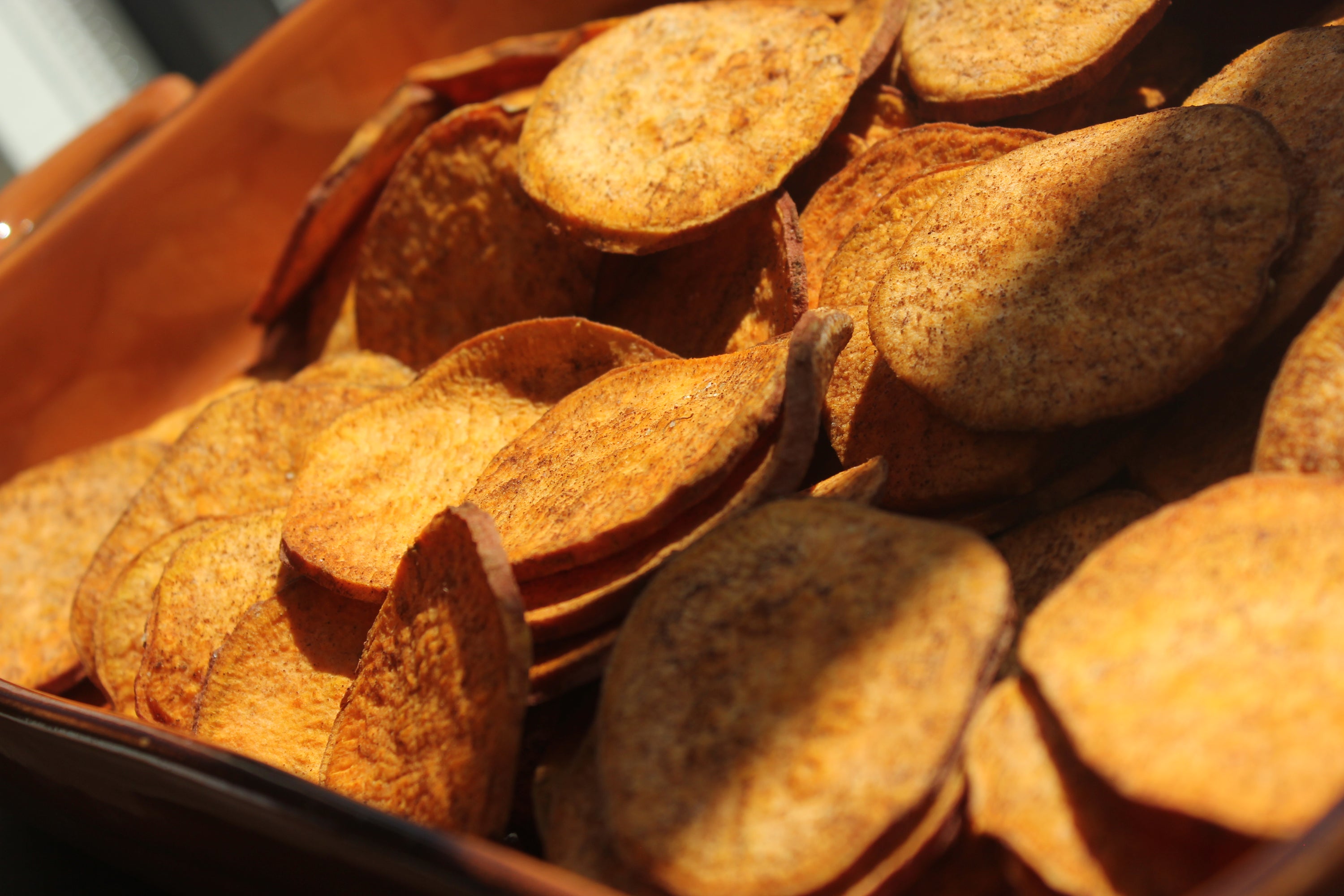 A close-up of organic cinnamon sweetpotato slices, showcasing their golden-brown color and texture, perfect for snacking or dessert toppings.