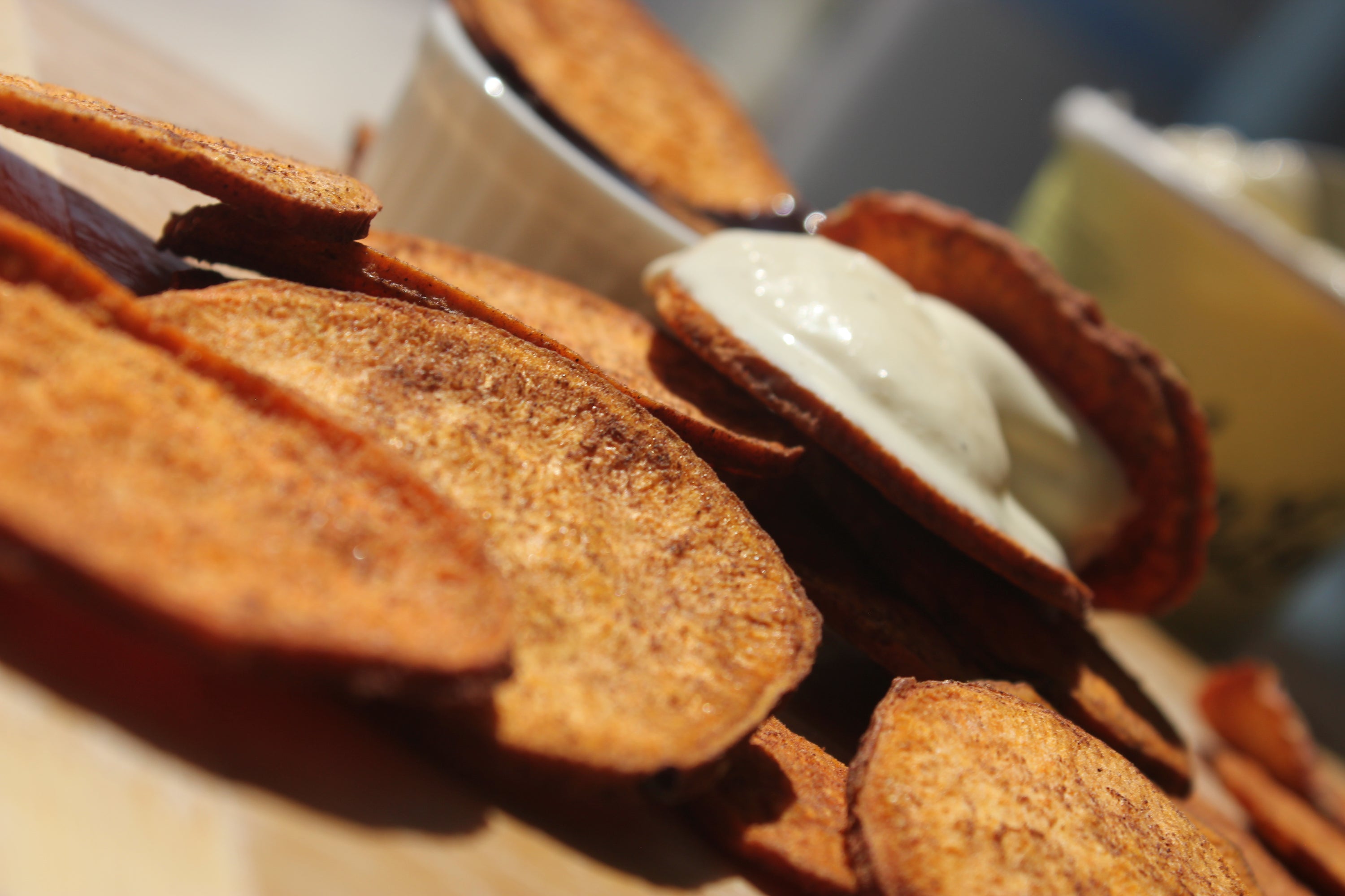 A close-up of organic cinnamon sweetpotato slices, showcasing their golden-brown color and texture, perfect for snacking or dessert toppings.