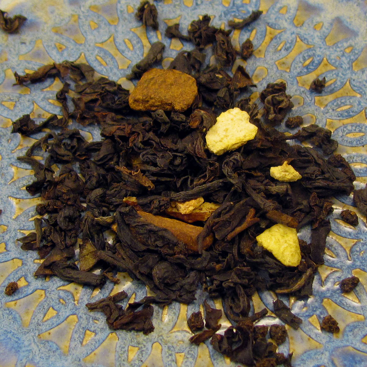 Cinnamon Orange Spice Loose Tea in a matte black signature tin, showcasing the blend of black tea, orange peel, and cinnamon chips.