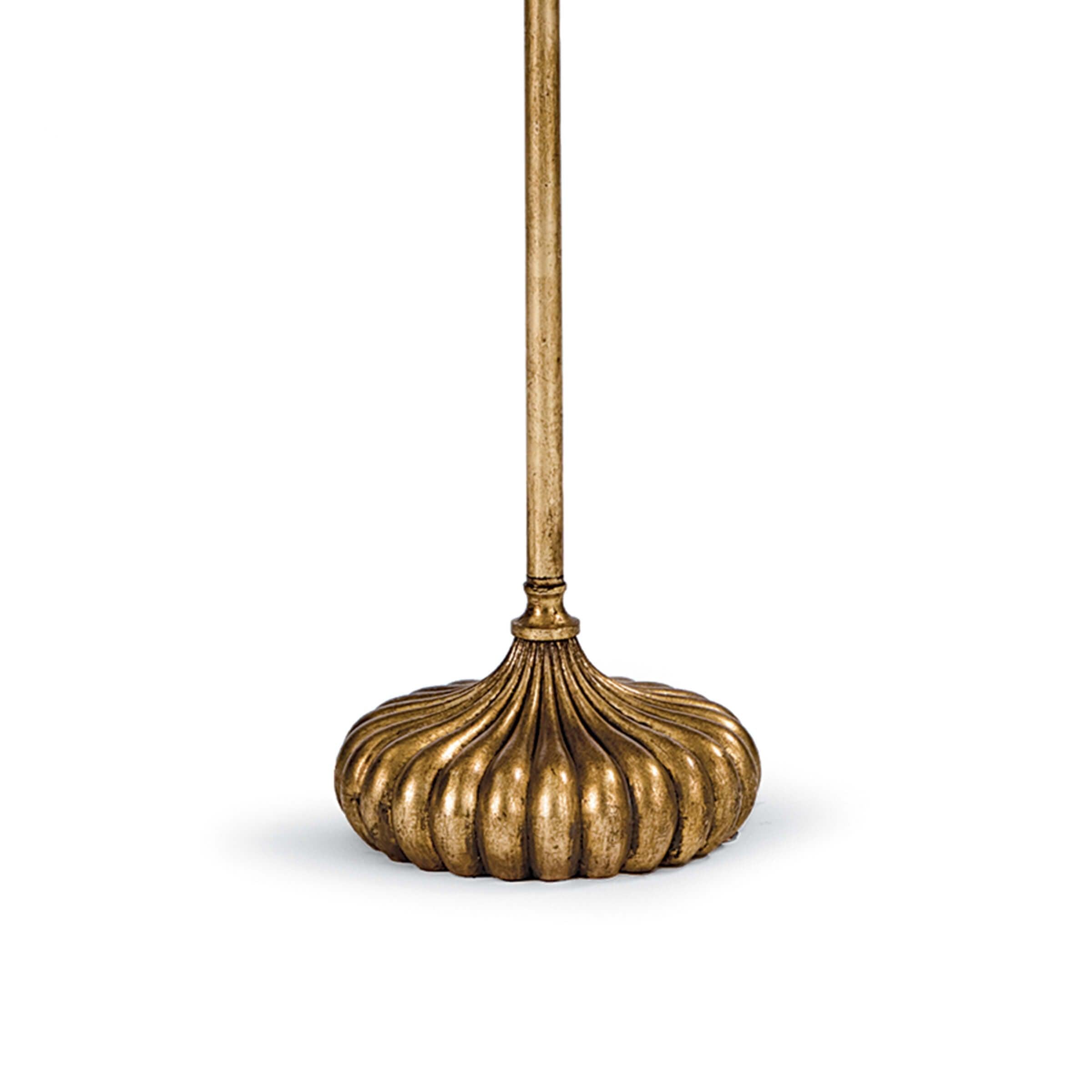 Clove Stem Floor Lamp with antiqued gold base and white linen shade, standing elegantly in a stylish room.