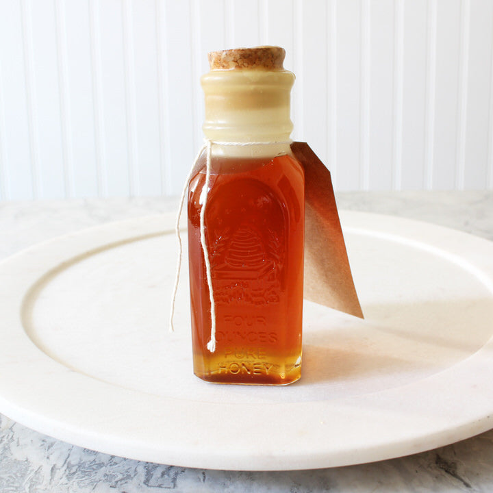 Colonial Honey Jar filled with pure wildflower honey, featuring a cork seal and beeswax dip, showcasing its vintage Muth design.