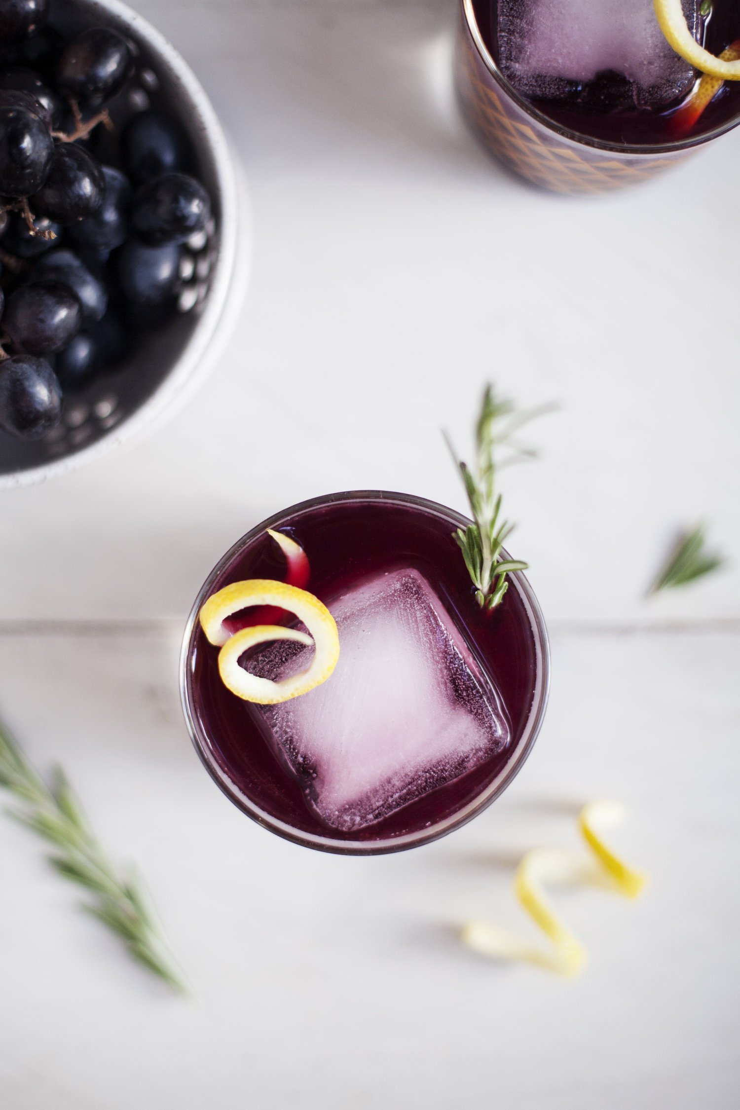 A 16oz bottle of Concord Grape Apple Infusion showcasing vibrant grape and apple colors, emphasizing its organic ingredients.