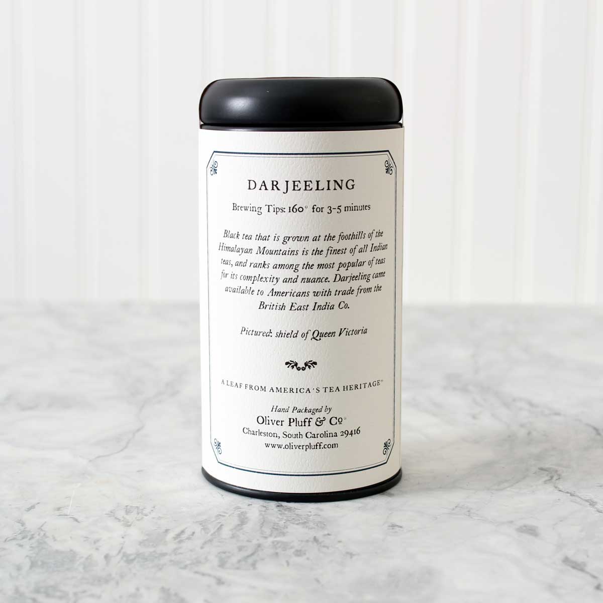 Darjeeling Loose Tea in a matte black signature tin, showcasing the premium quality of the tea leaves inside.