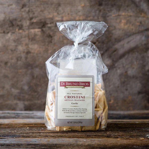 A package of DiBruno Brothers Garlic Crostini showcasing crispy, golden-brown crostini with a garlic aroma.