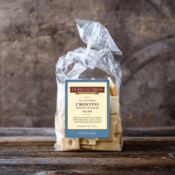 A package of DiBruno Brothers Sea Salt Crostini, showcasing the crunchy texture and perfect size for pairing with cheeses and dips.