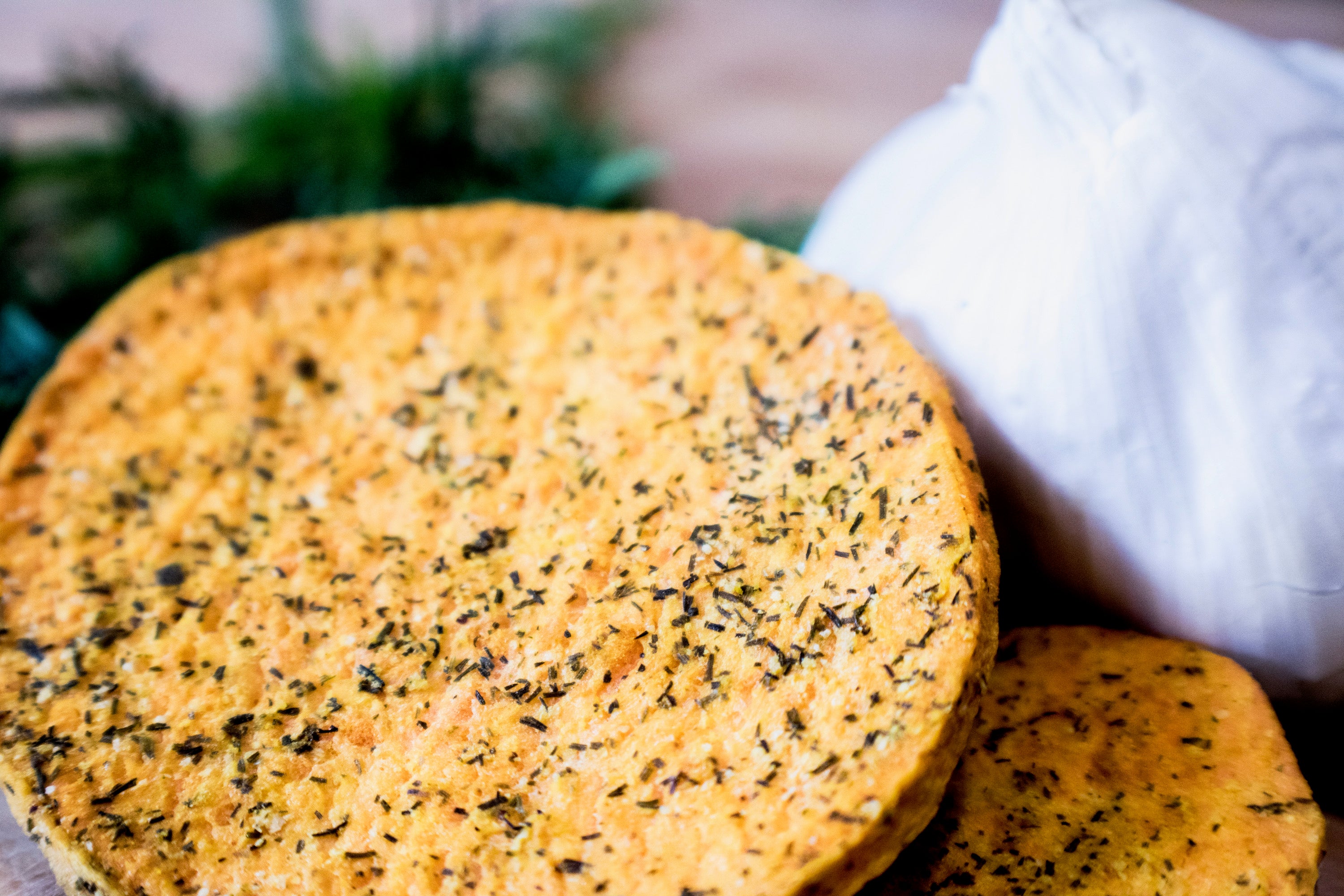 A close-up of Dill and Garlic slices, showcasing their crispy texture and seasoning of dill and garlic granules.