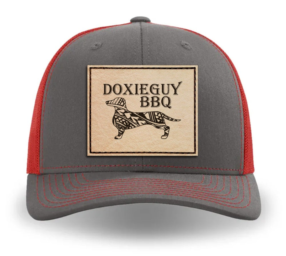 DoxieGuy BBQ Leather Patch Trucker Cap in Heather Gray and Red with a natural leather patch.