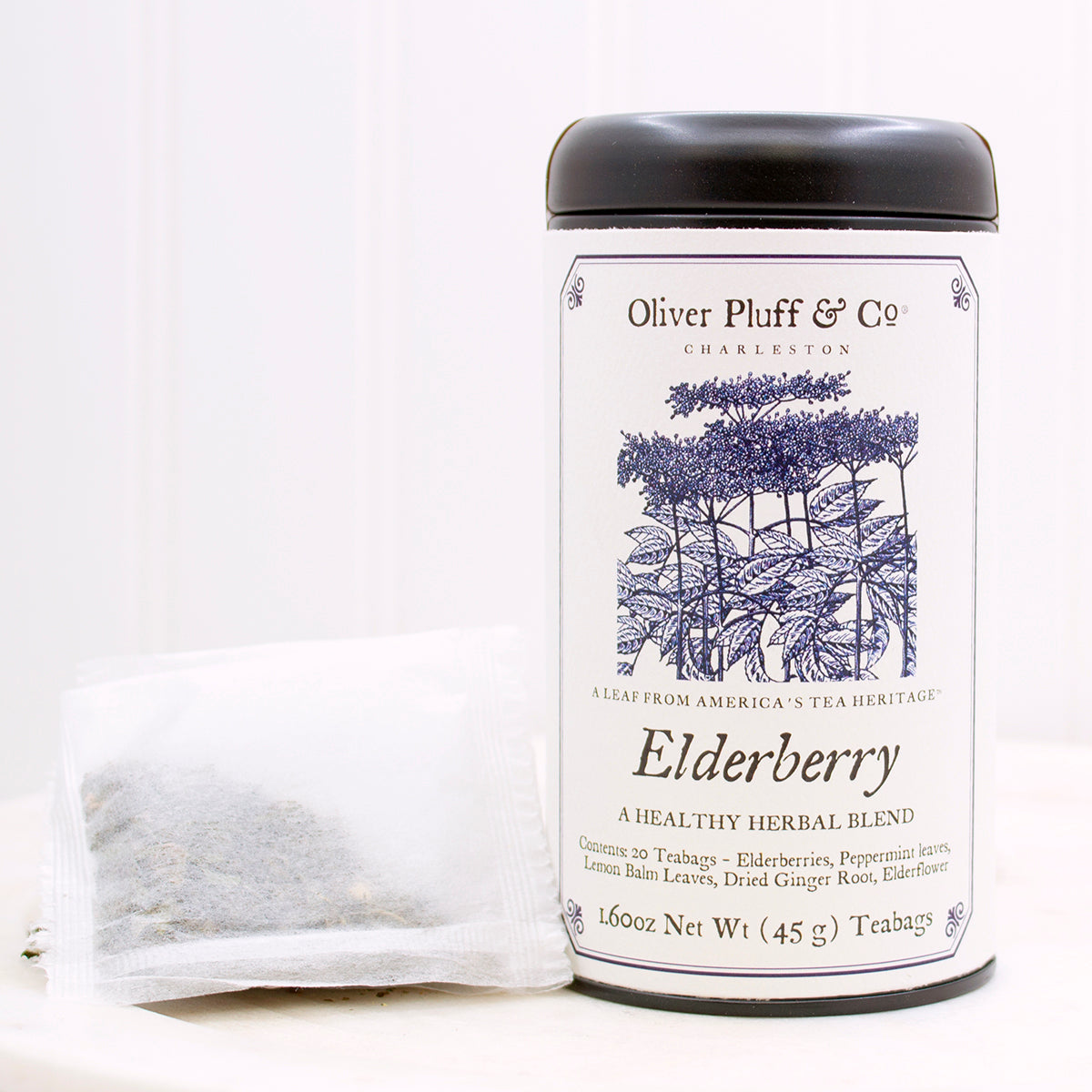 Elderberry Teabags Tea Tin featuring a matte black design with 20 pillow sachet teabags inside, showcasing natural ingredients.